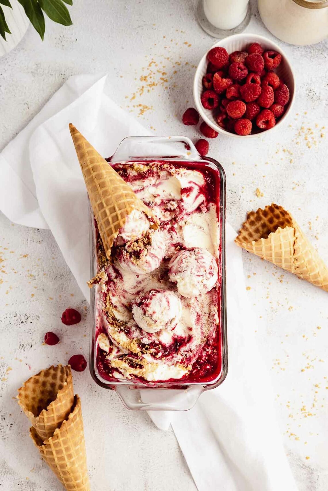 raspberry cheesecake ice cream with ribbons of raspberries and graham crumbs