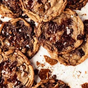 Toffee cookies on baking tray with crushed toffee pieces and chocolate
