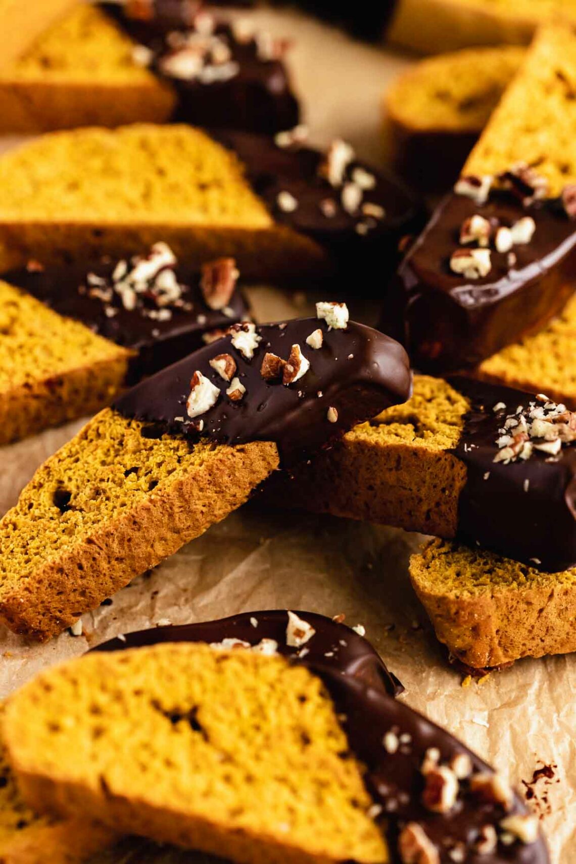 pumpkin biscotti covered in chocolate and chopped pecans