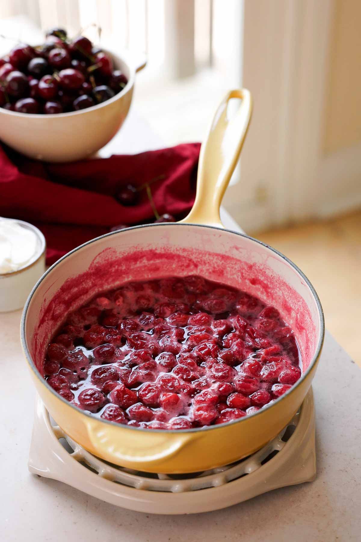 simmering tart cherries in a saucepan