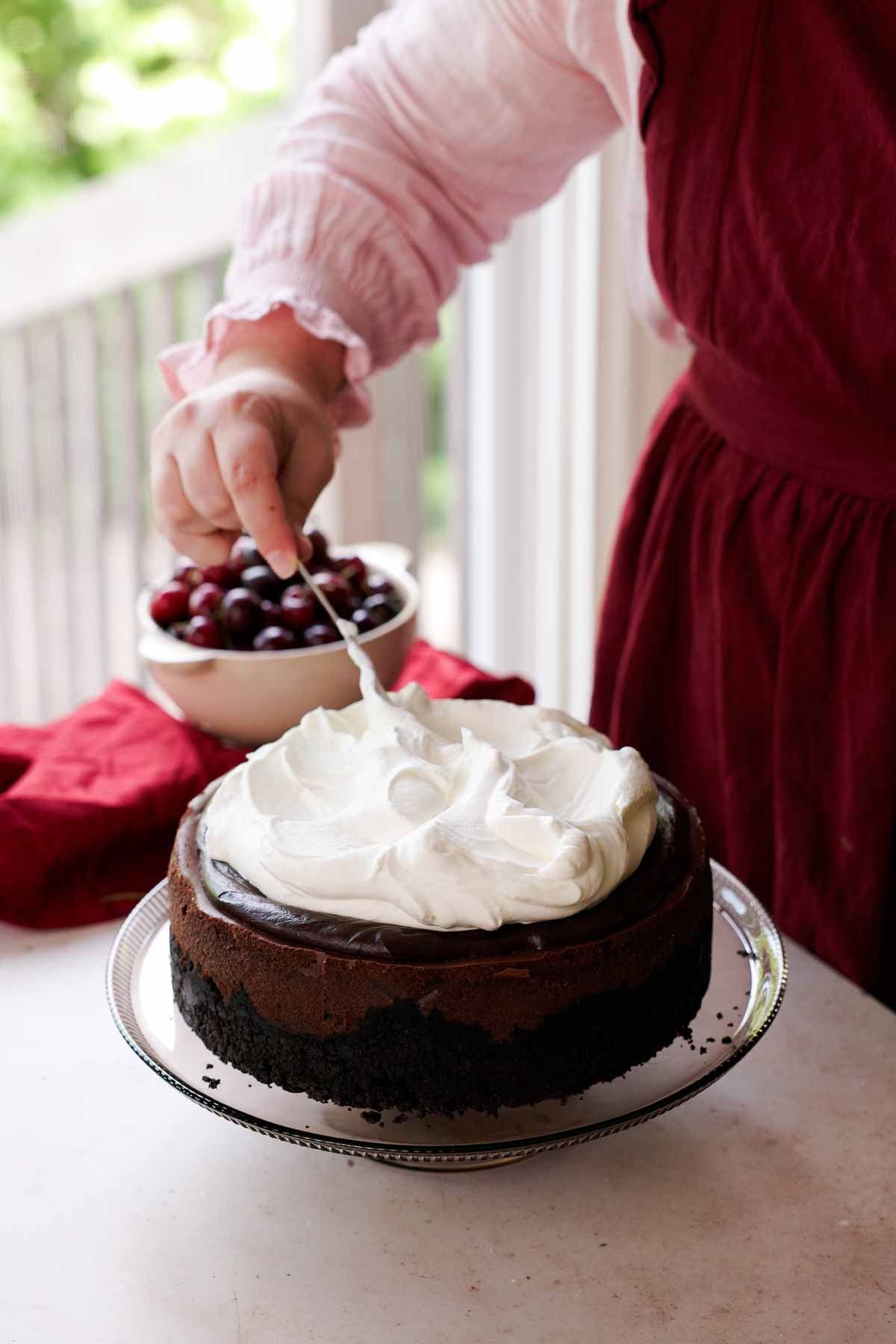 topping cheesecake with whipped cream