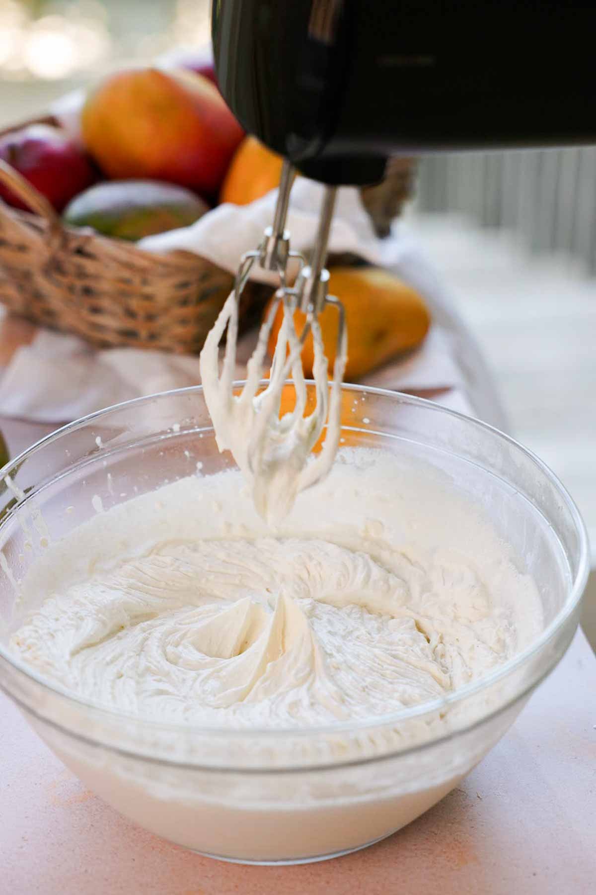 whipping cream and mascarpone cheese to stiff peaks in large glass bowl