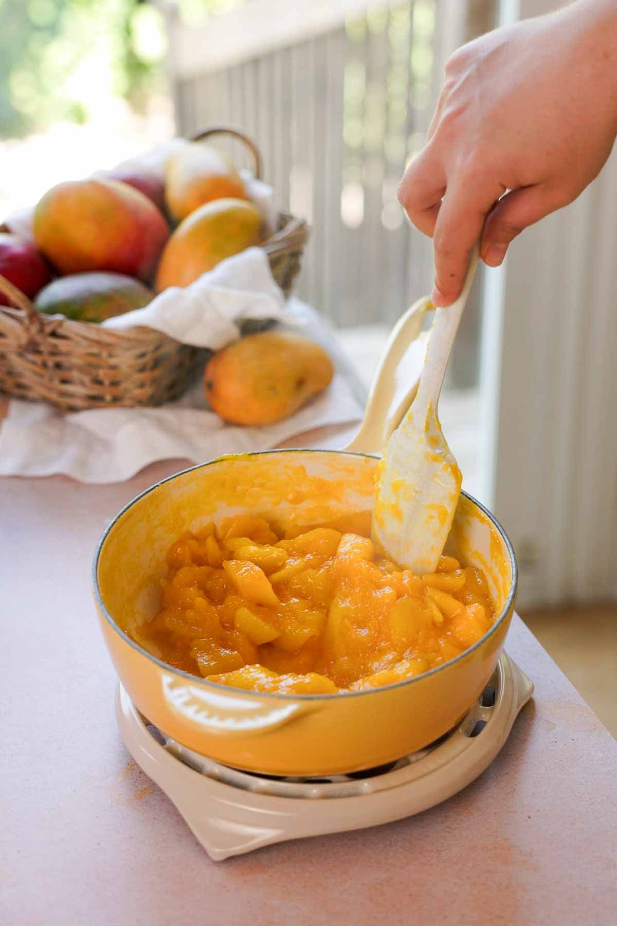 cooking mango chunks in saucepan