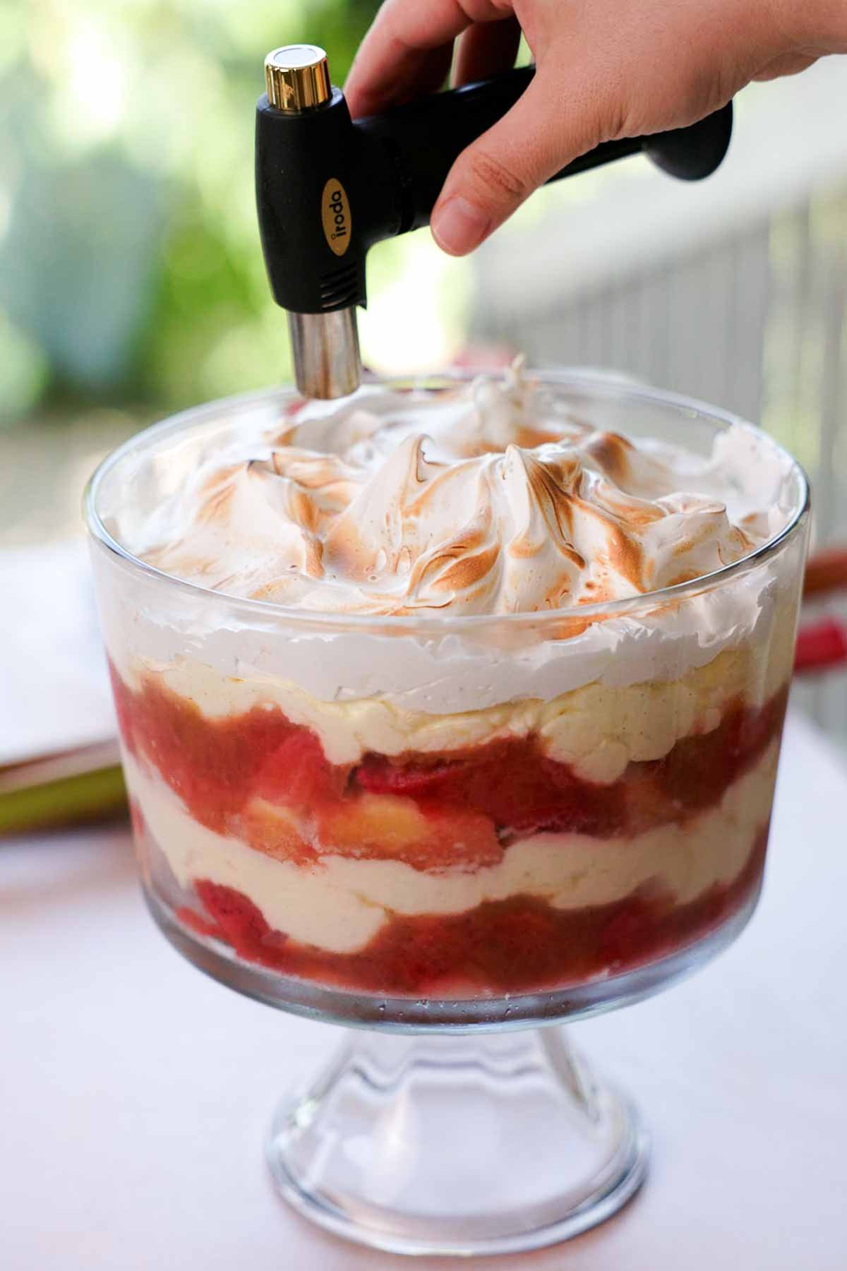toasting top of meringue with kitchen torch