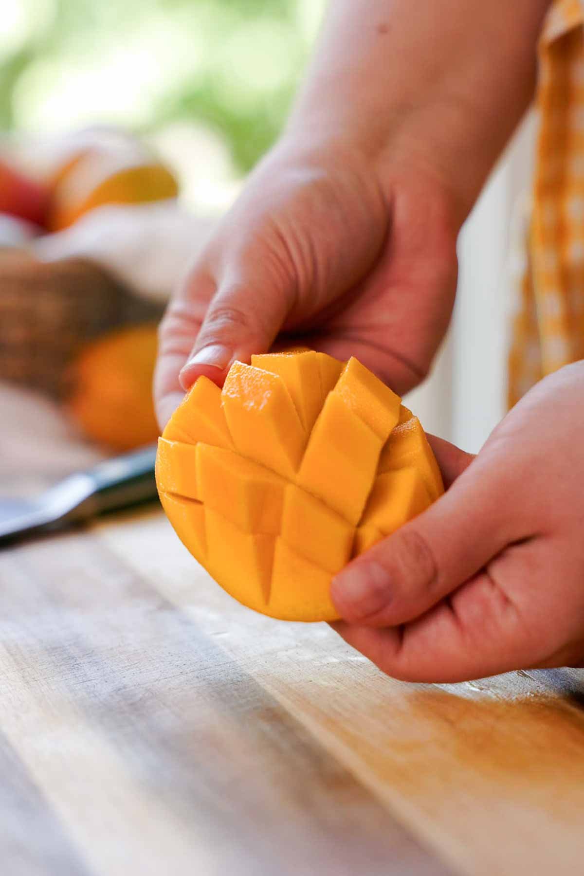 flipping mango skin inside out to show mango chunks