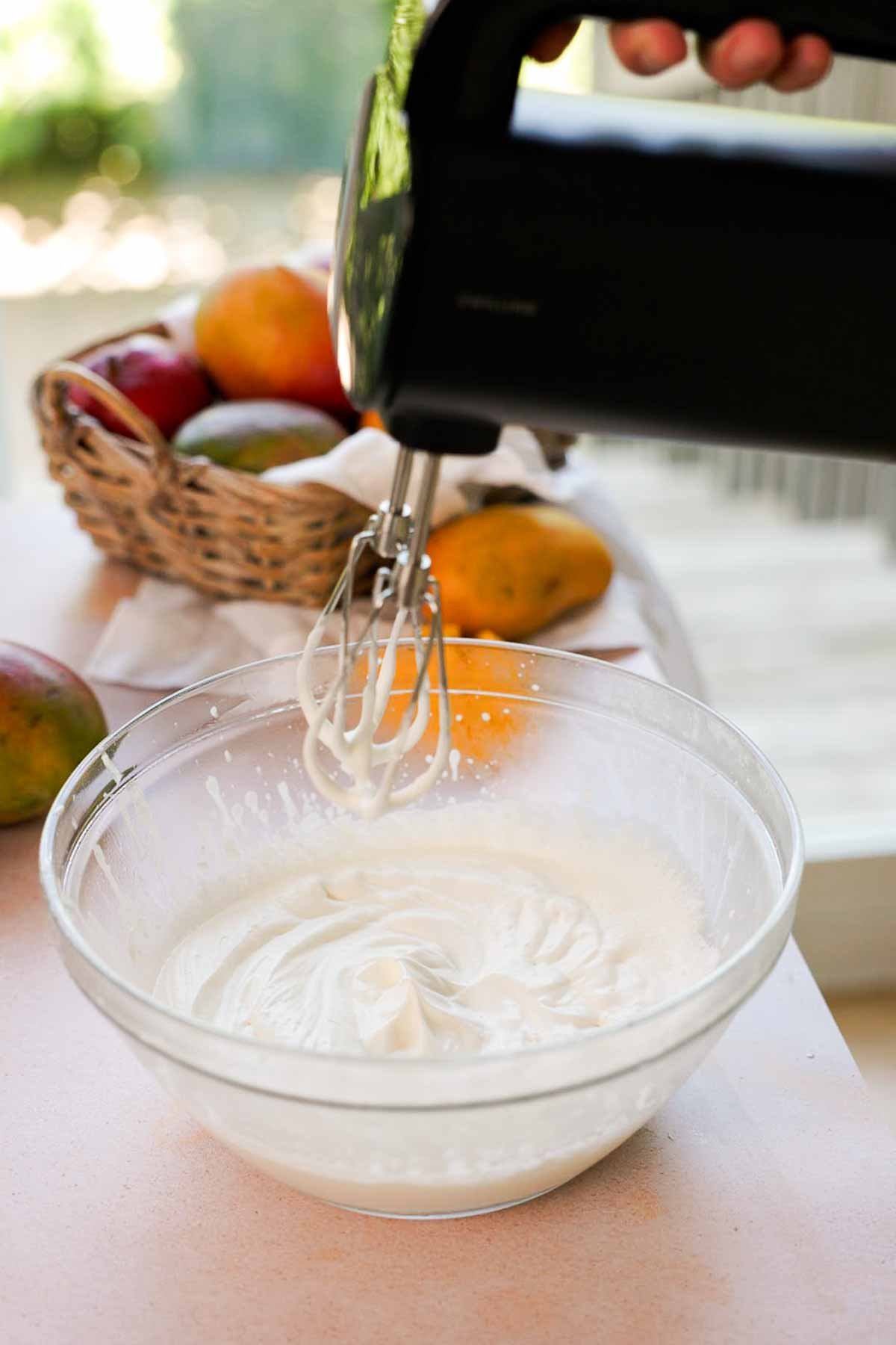 whipping cream to stiff peaks in large glass bowl