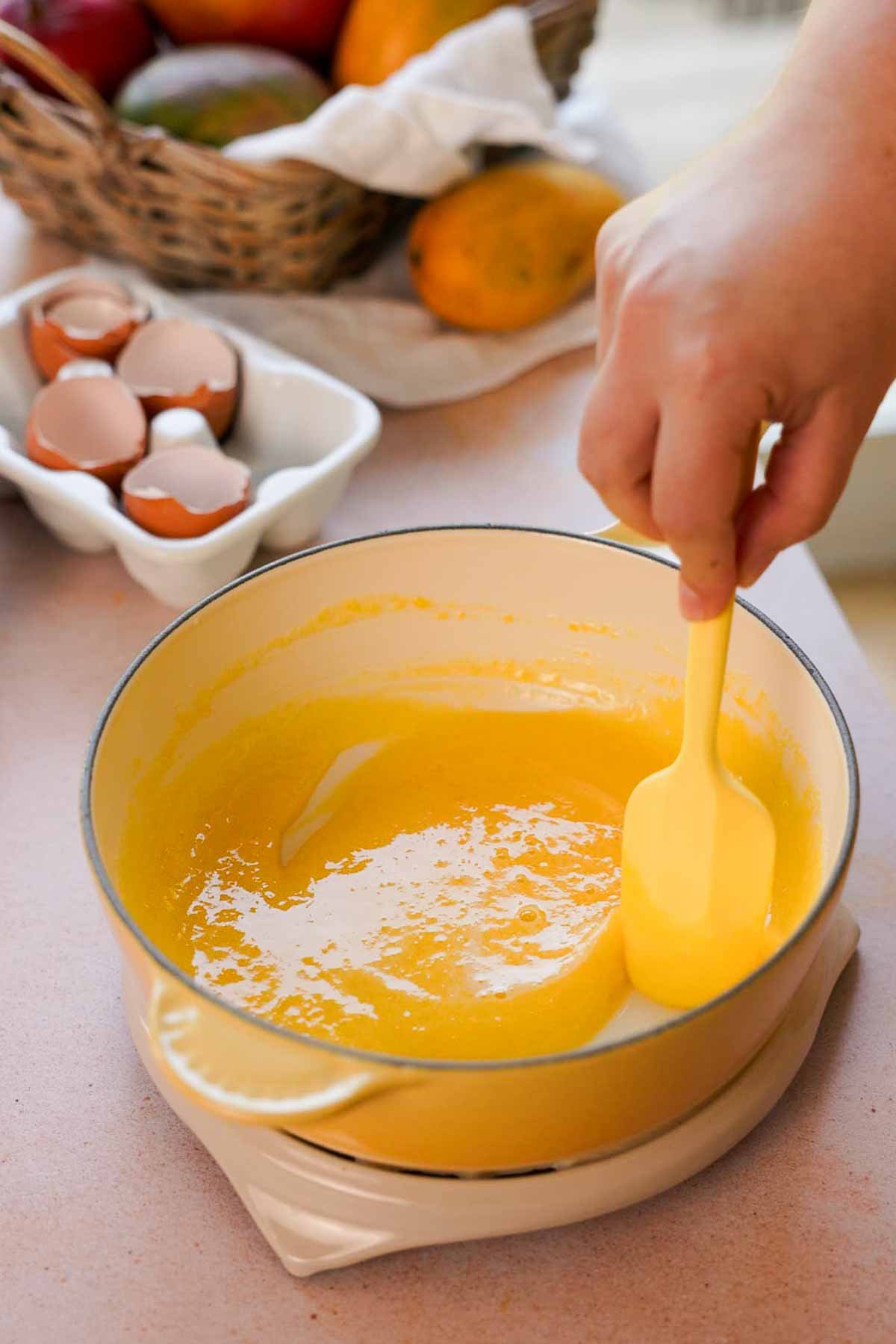 stirring yolks and sugar in saucepan