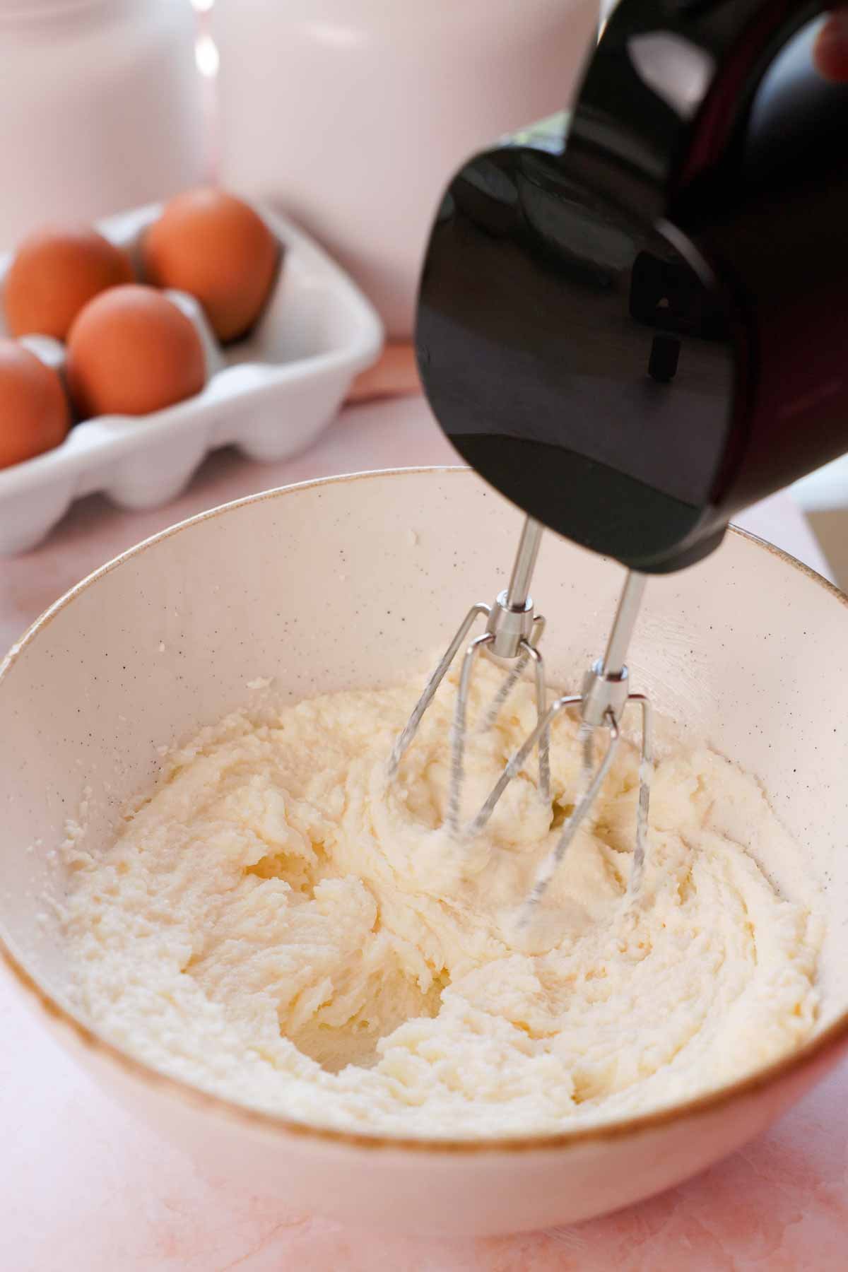 beating butter, oil, and sugar with electric mixer