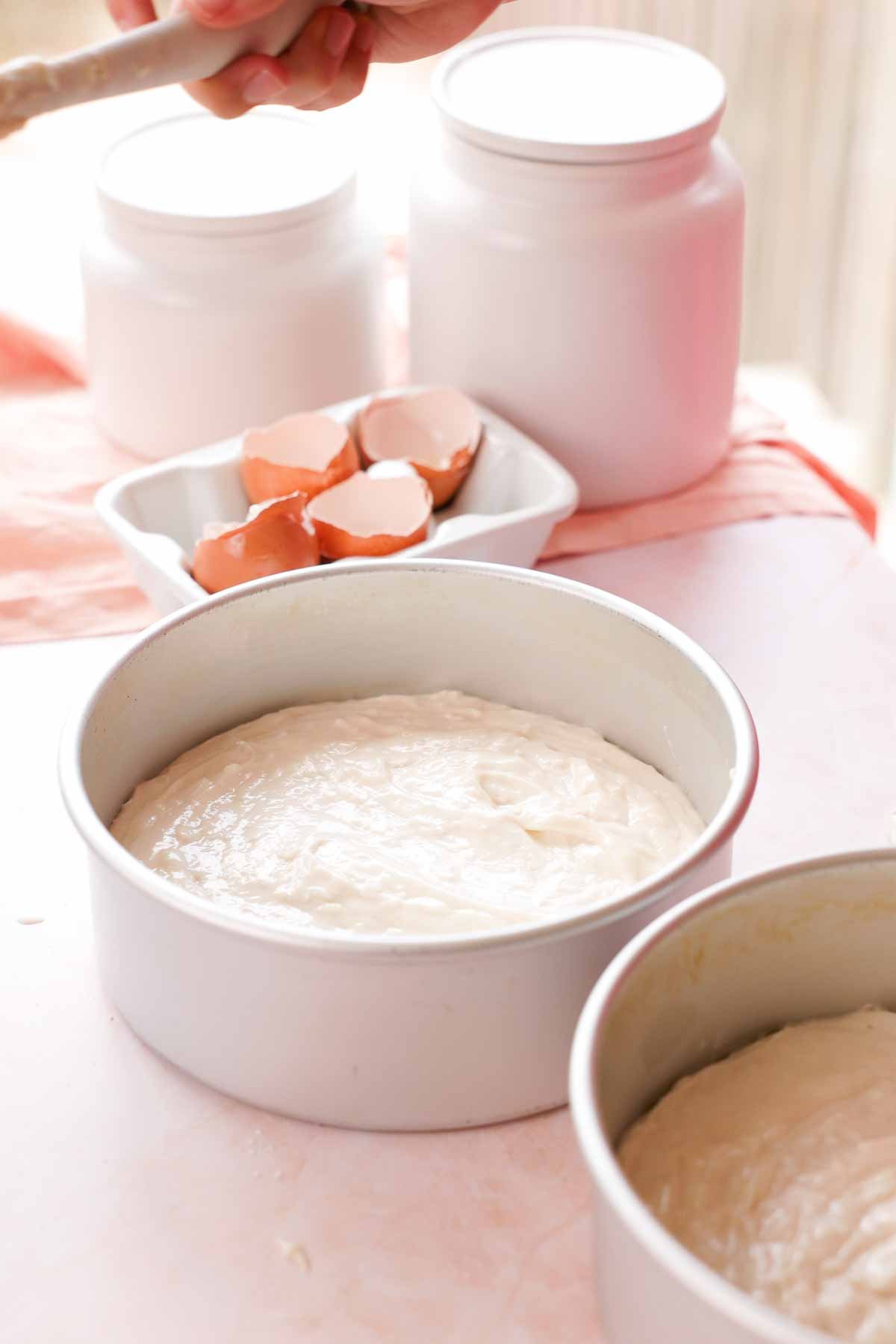 coconut cake batter in cake pans
