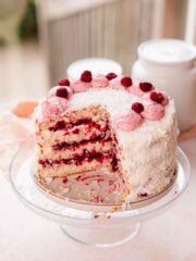coconut cake with raspberry filling and raspberries on top