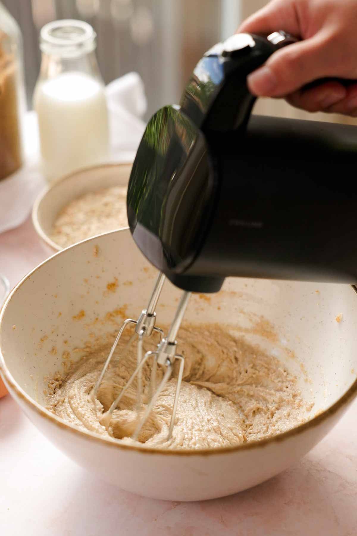 creaming butter, oil, and sugar in a bowl for oatmeal ice cream sandwiches