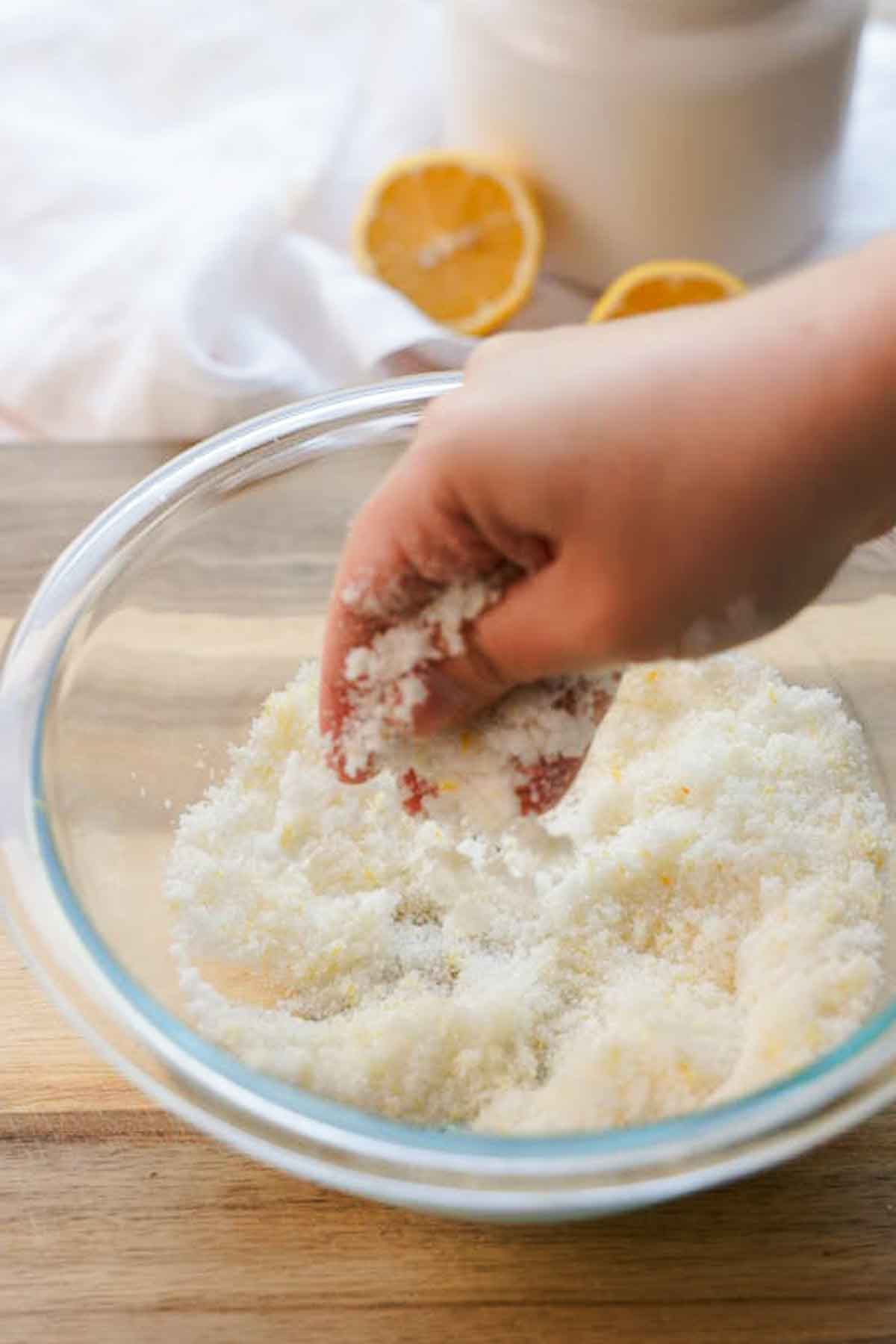 rubbing lemon zest and sugar together in a large glass bowl