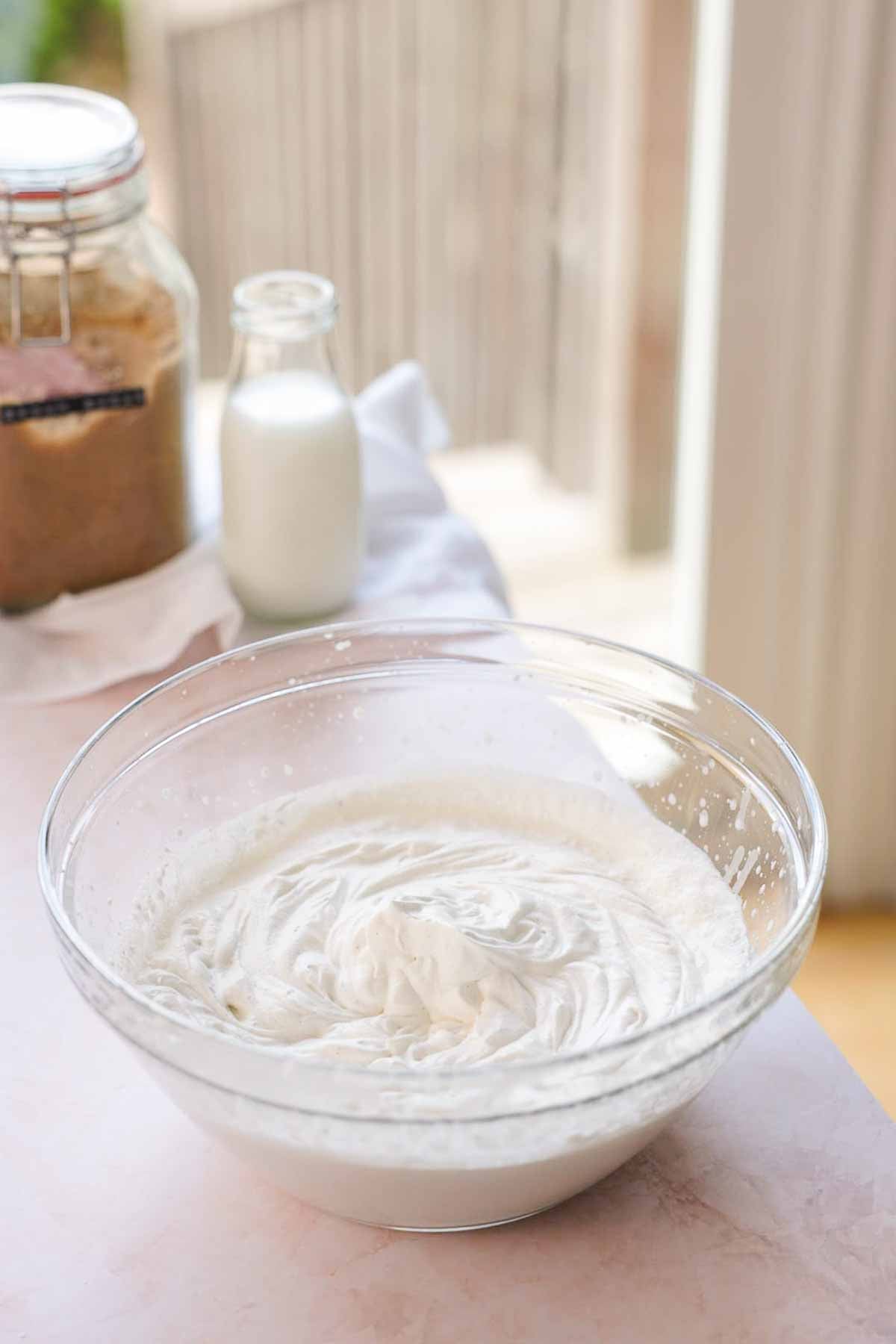 cream whipped to stiff peaks in a large glass bowl
