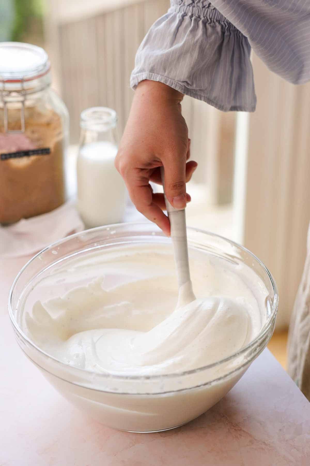 folding no churn vanilla ice cream with a spatula