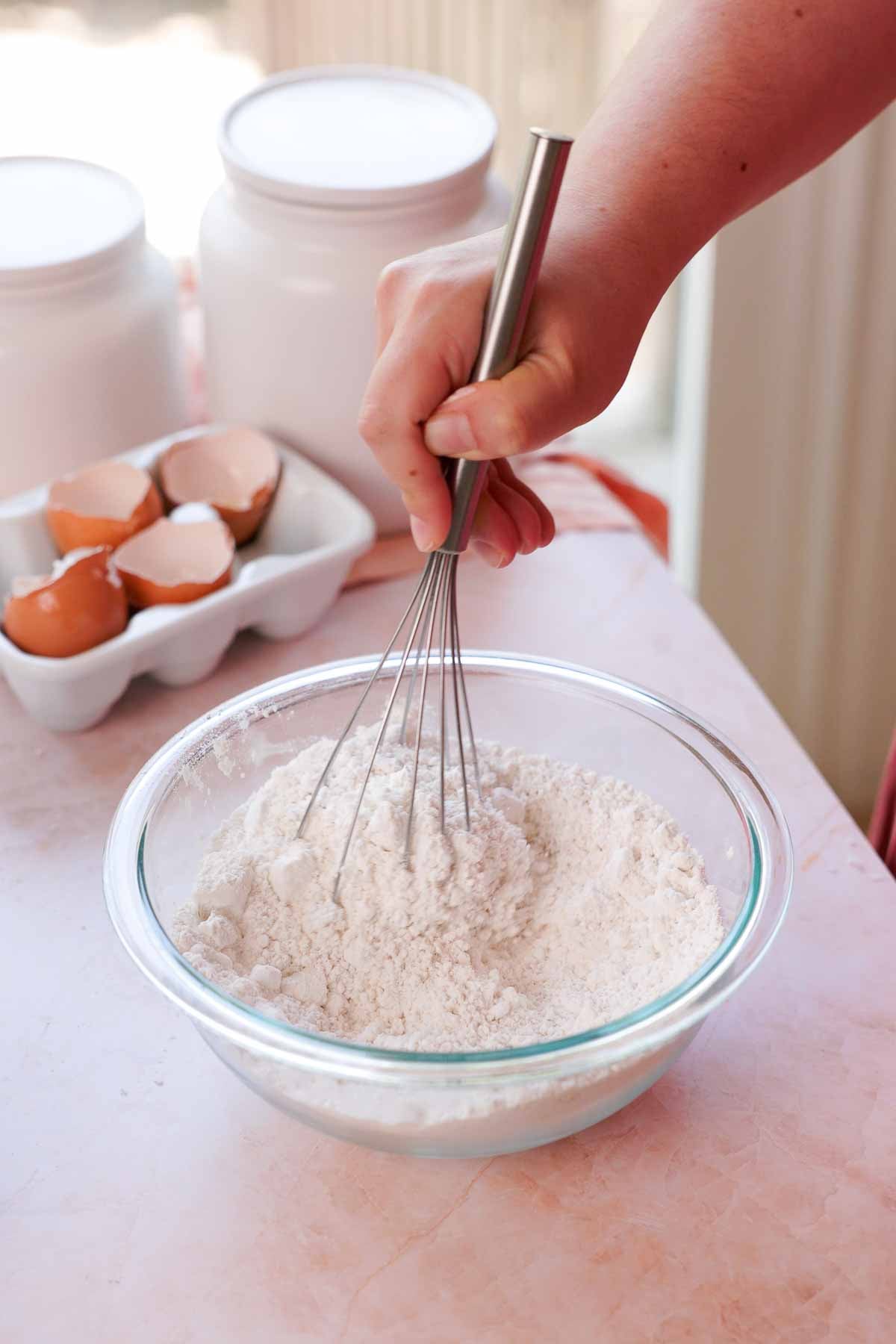 whisking dry ingredients together in a bowl