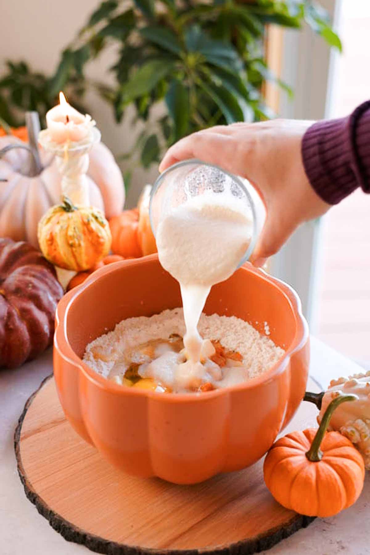 pouring dissolved yeast into bowl for pumpkin monkey bread dough