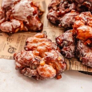 apple fritters with cheddar cheese on parchment paper
