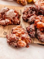 apple fritters with cheddar cheese on parchment paper