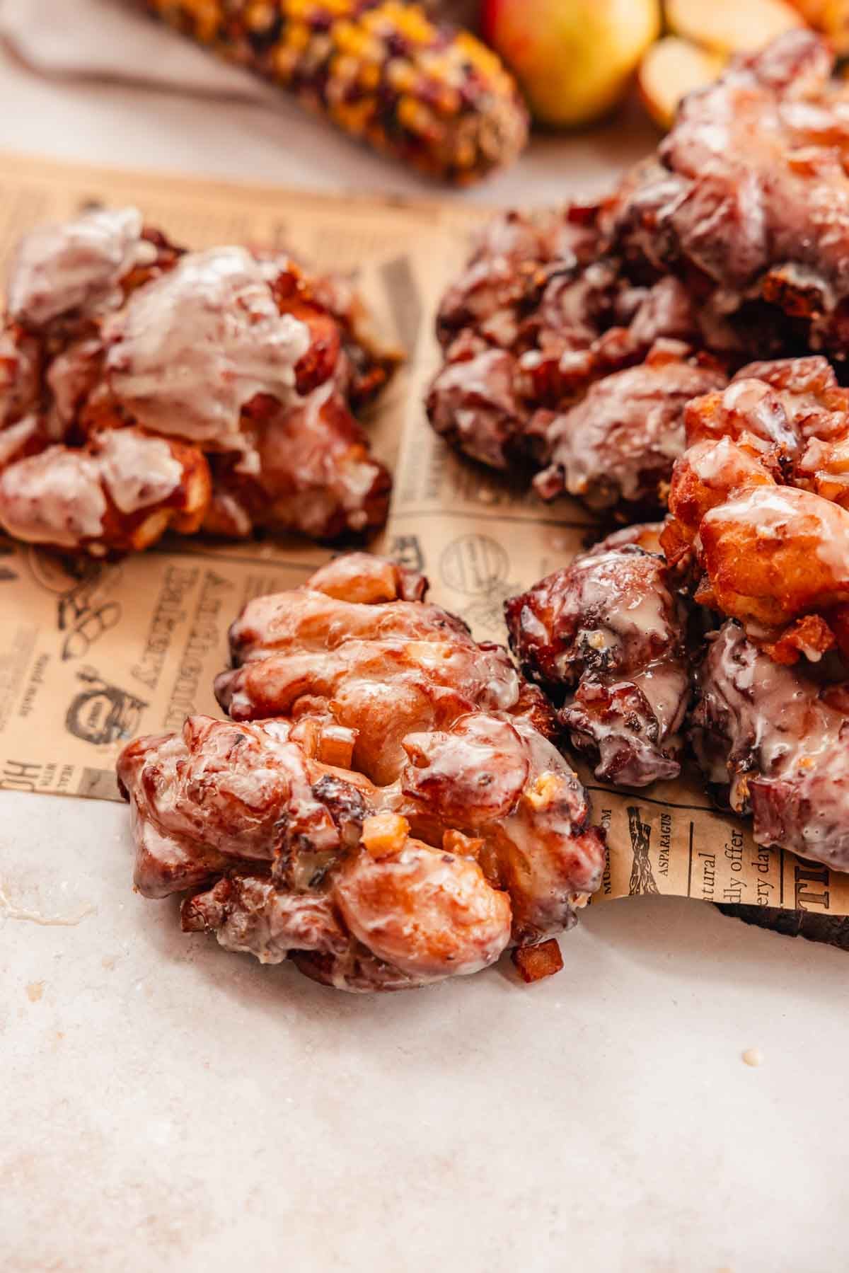 apple fritters with cheddar cheese on parchment paper