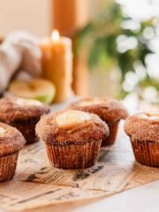 apple cider muffins arranged on parchment paper