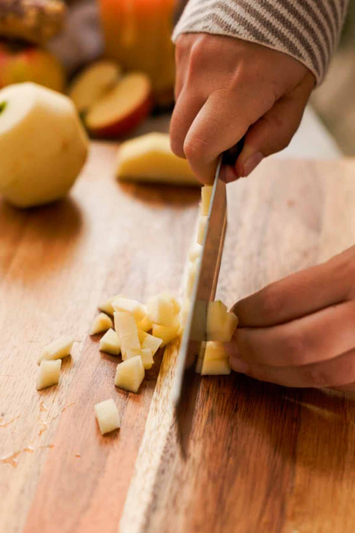 cutting peeled apples into small cubes