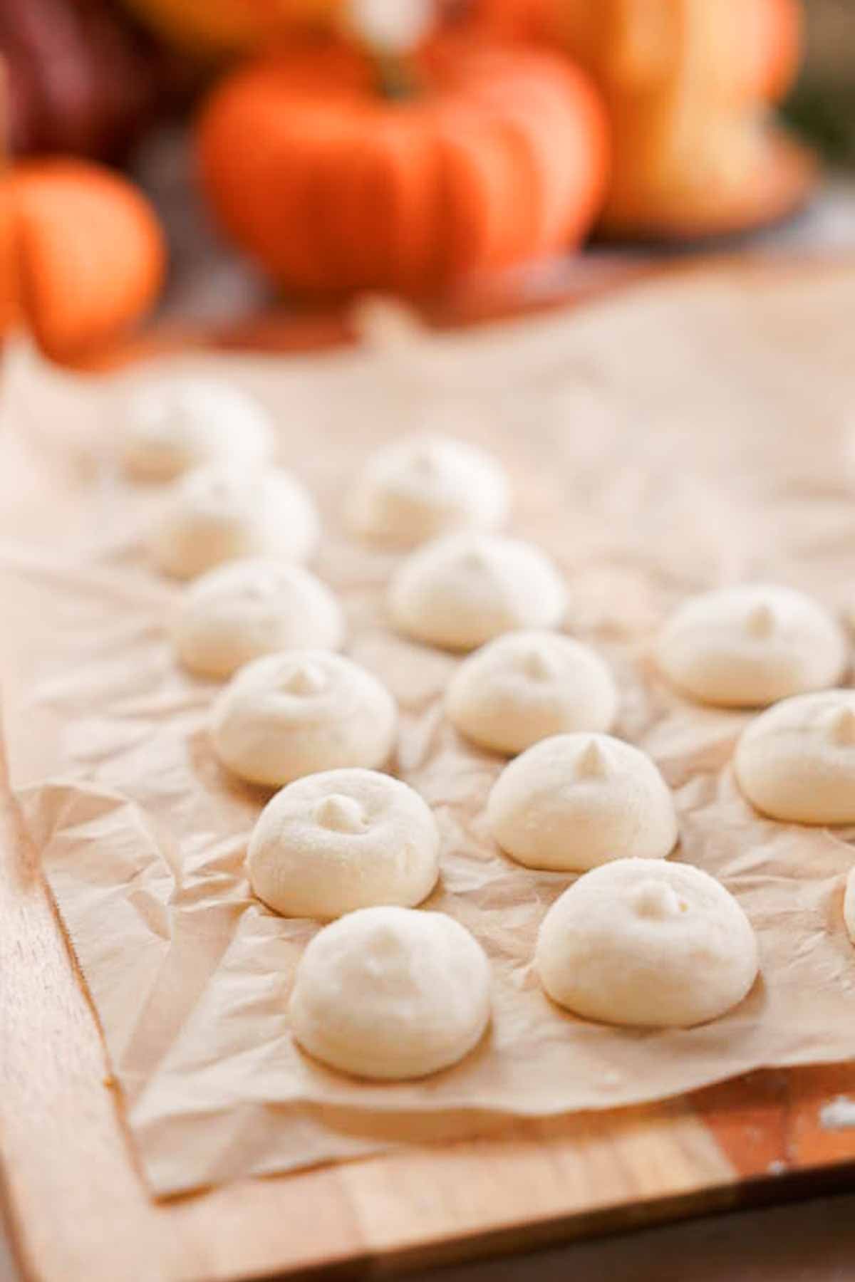 piped cream cheese filling frozen on parchment paper