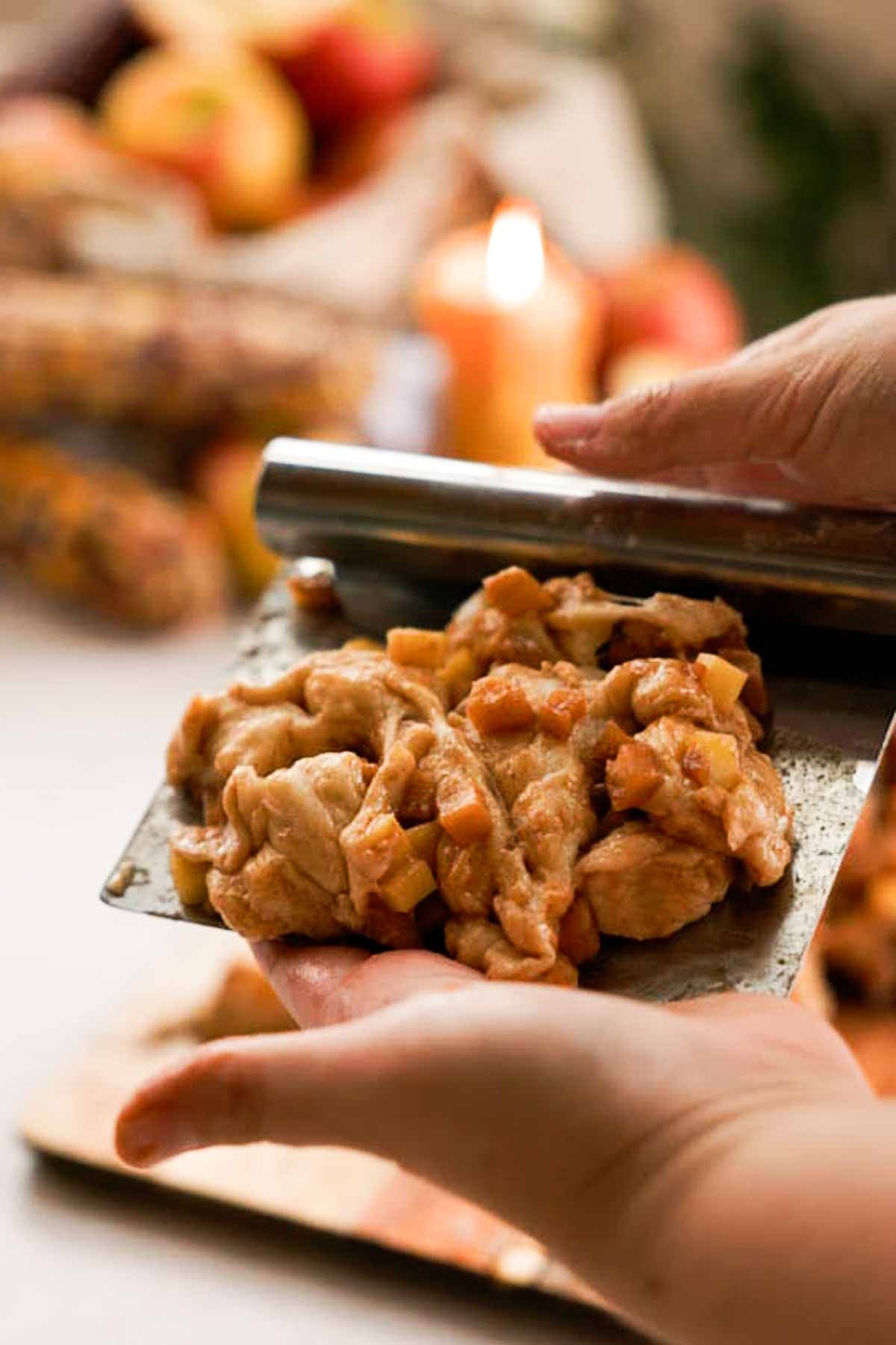 shaping apple fritters on a bench scraper