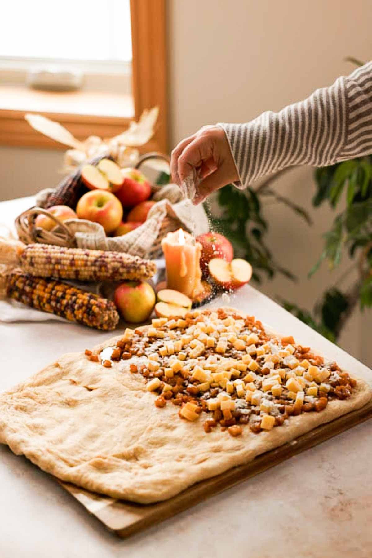 sprinkling apple filling and cheese with flour