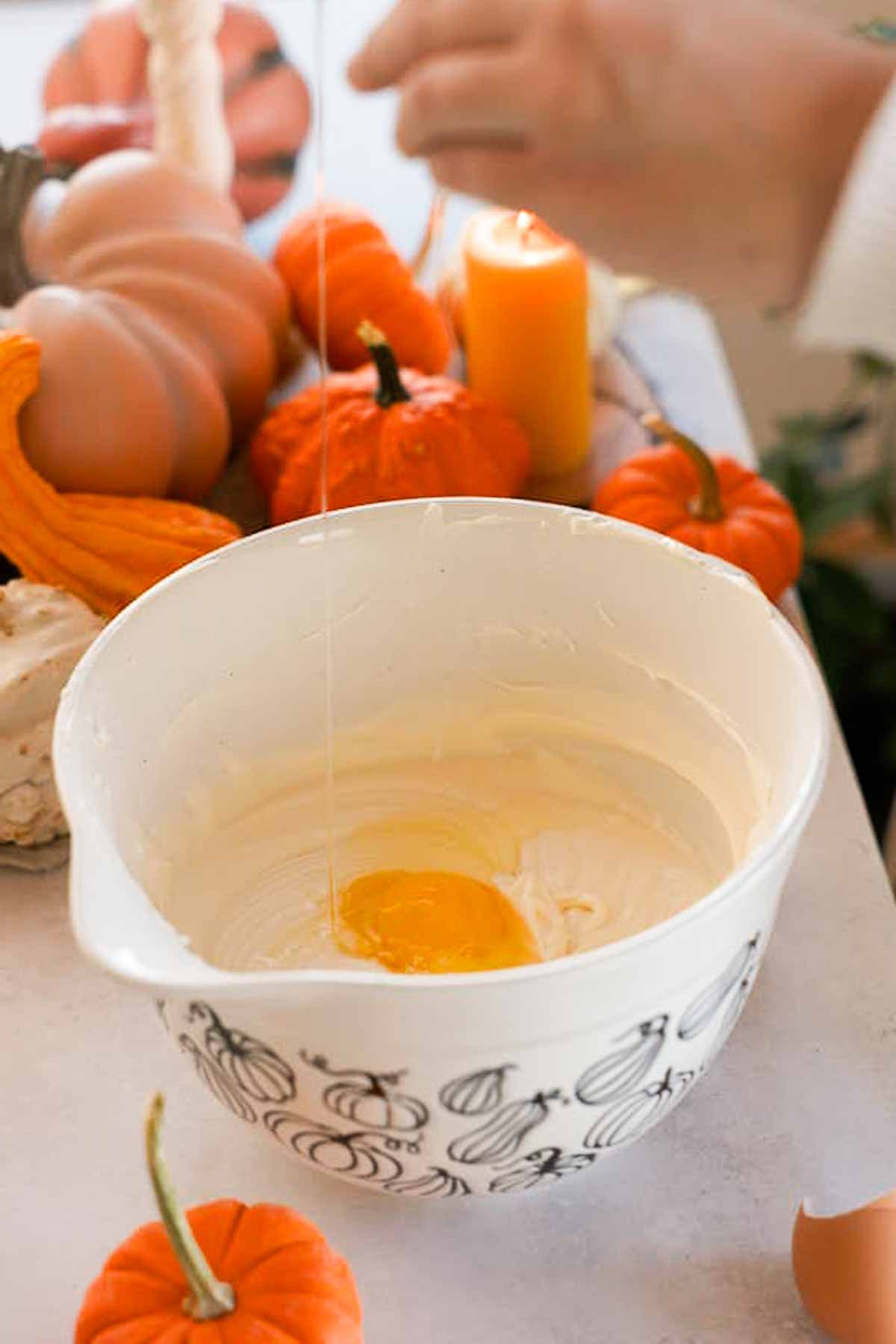 adding eggs into vanilla cheesecake batter