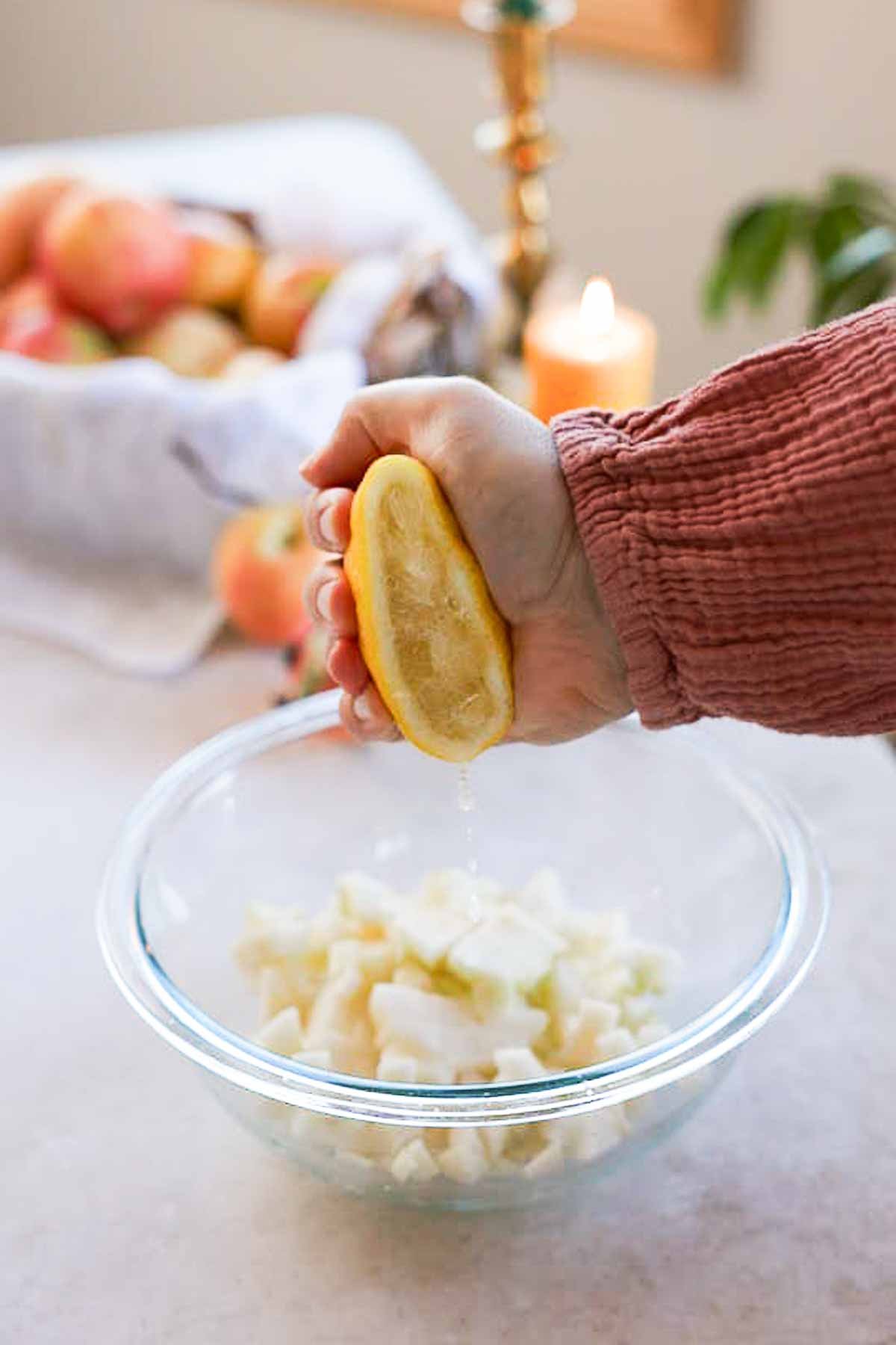 squeezing half a lemon into diced apples