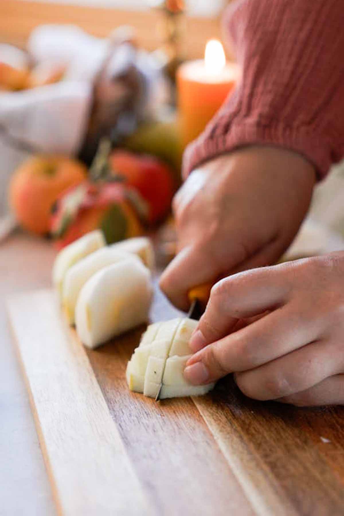 cutting apples into small cubes on a cutting board