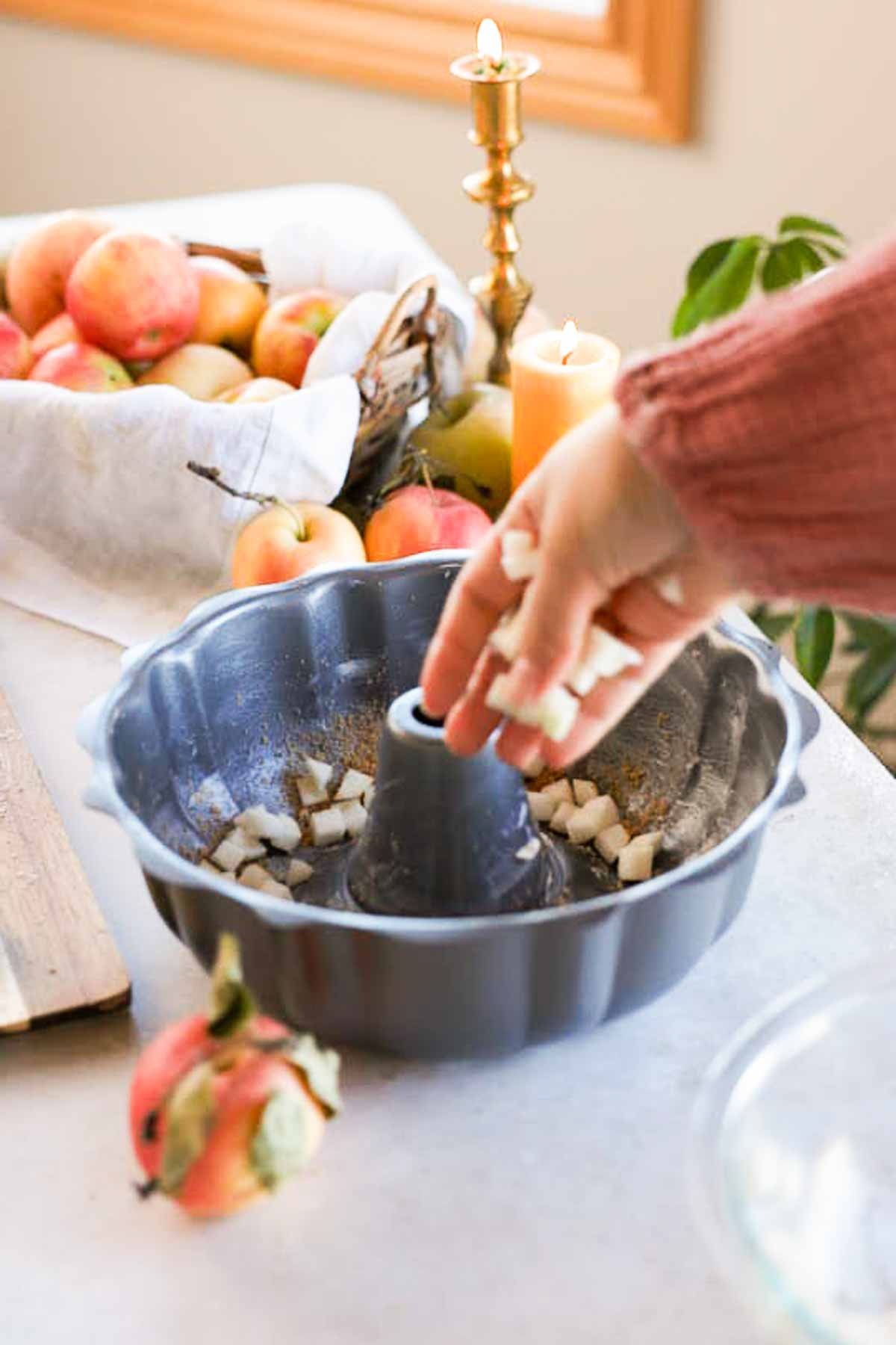 sprinking diced apples into bundt pan