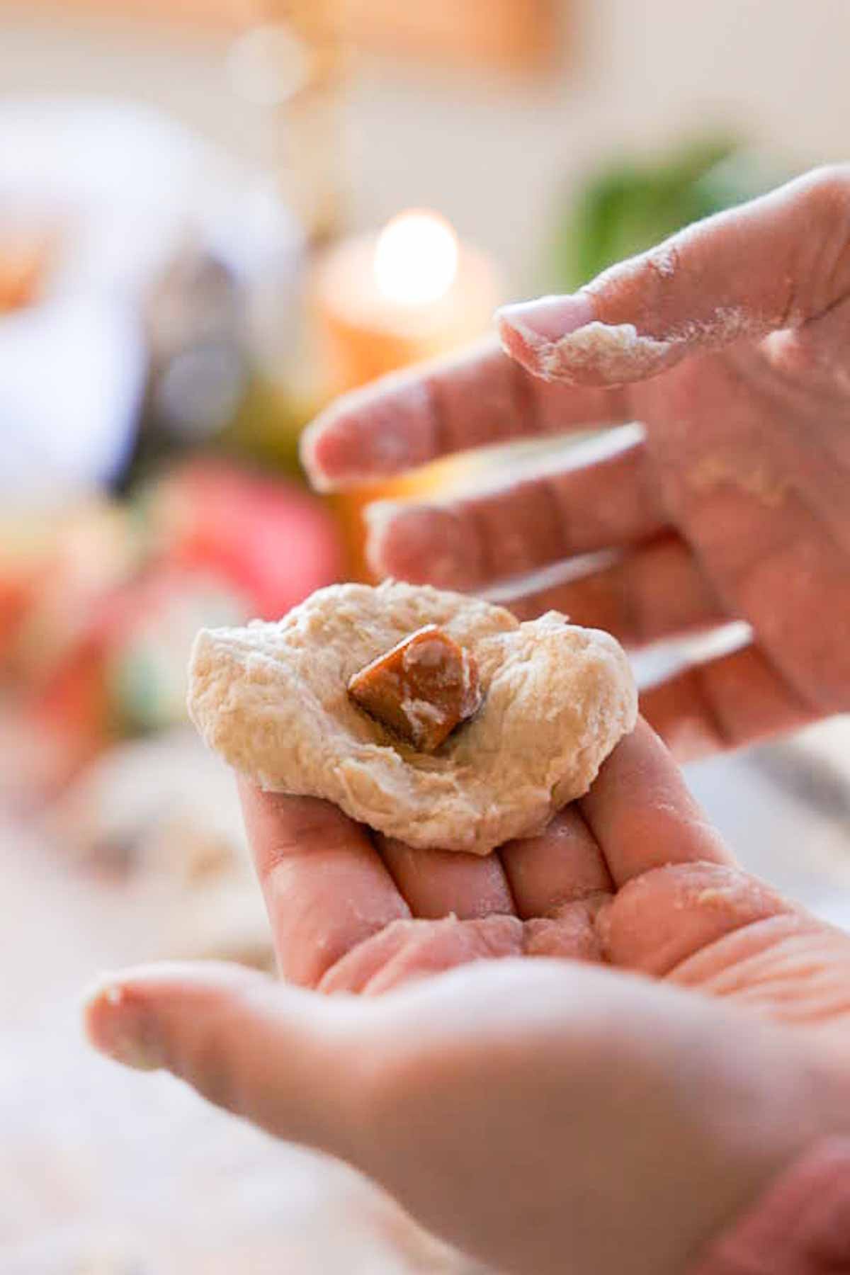 stuffing pieces of caramel into dough