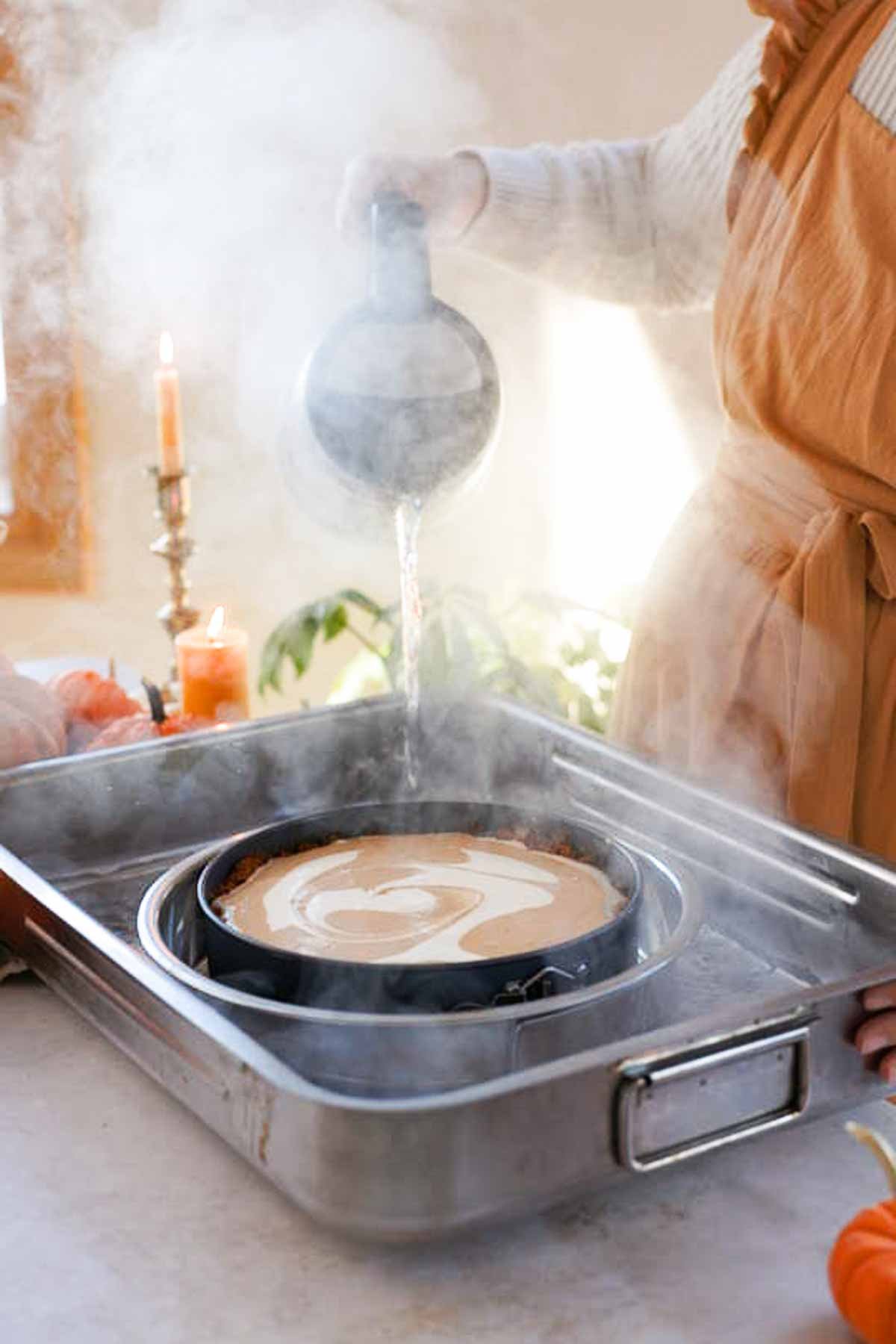 pouring hot water into cheesecake water bath