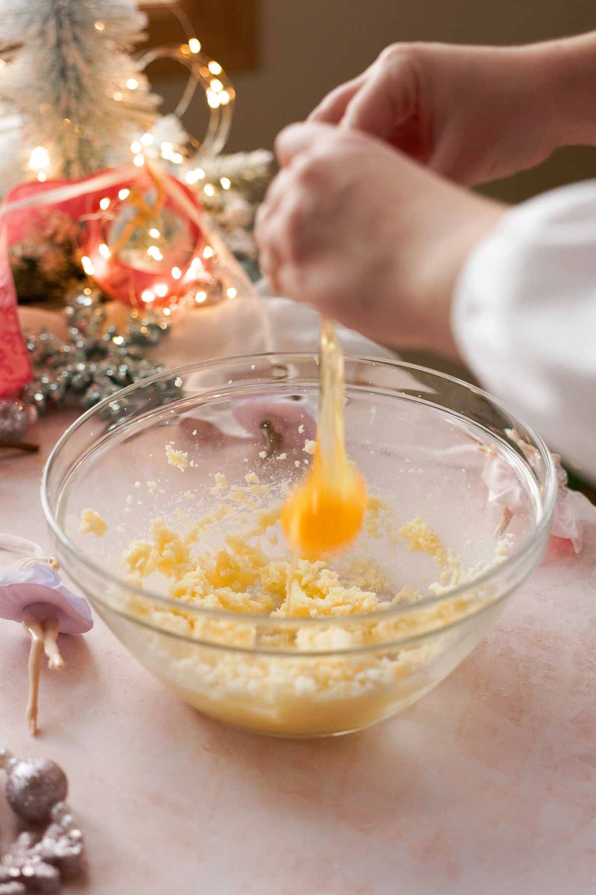 adding eggs into butter and sugar for caramel sugar cookie dough