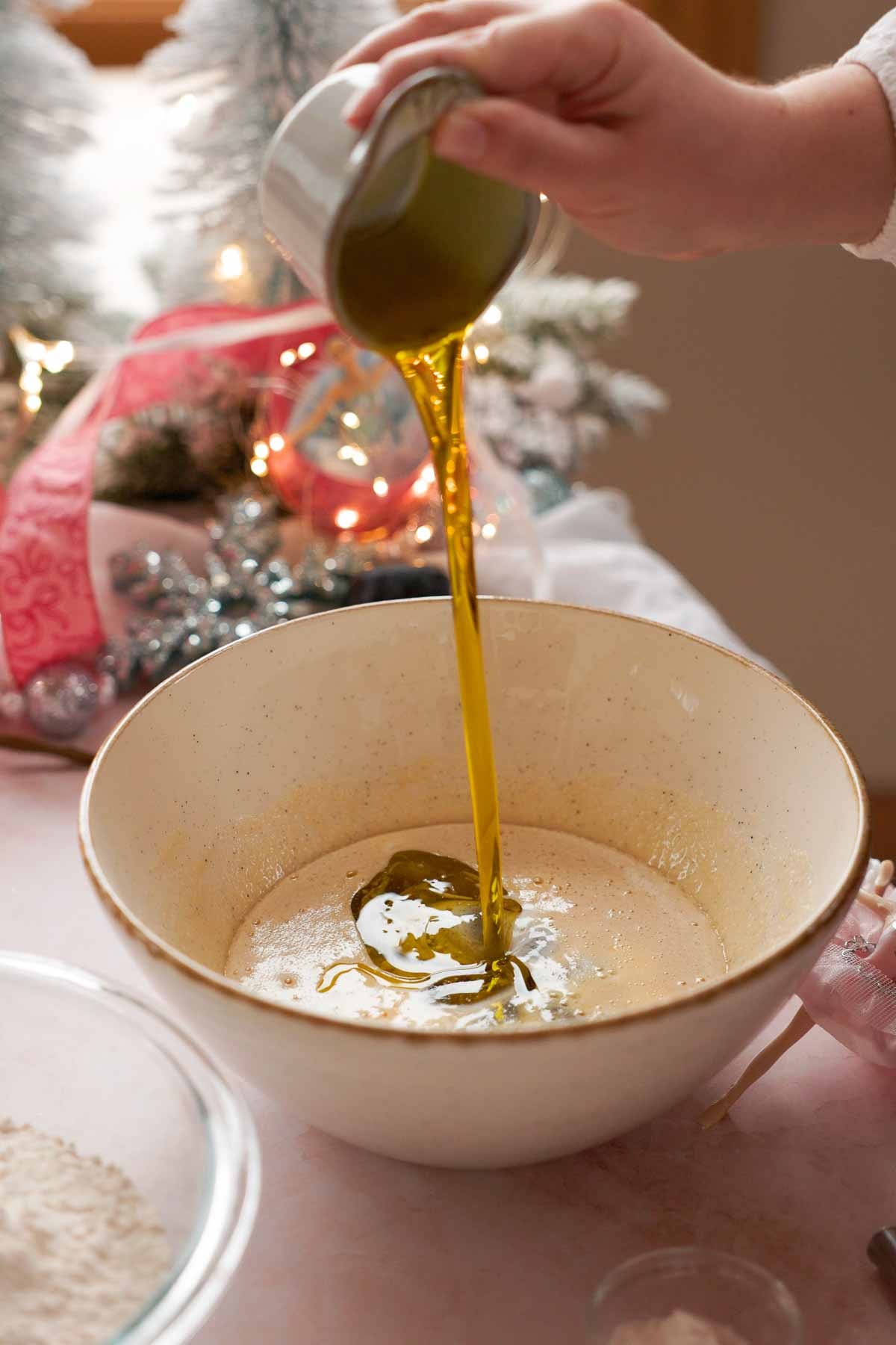 adding olive oil into cookie dough batter