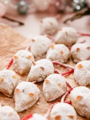 christmas mice cookies dusted with powdered sugar on parchment paper