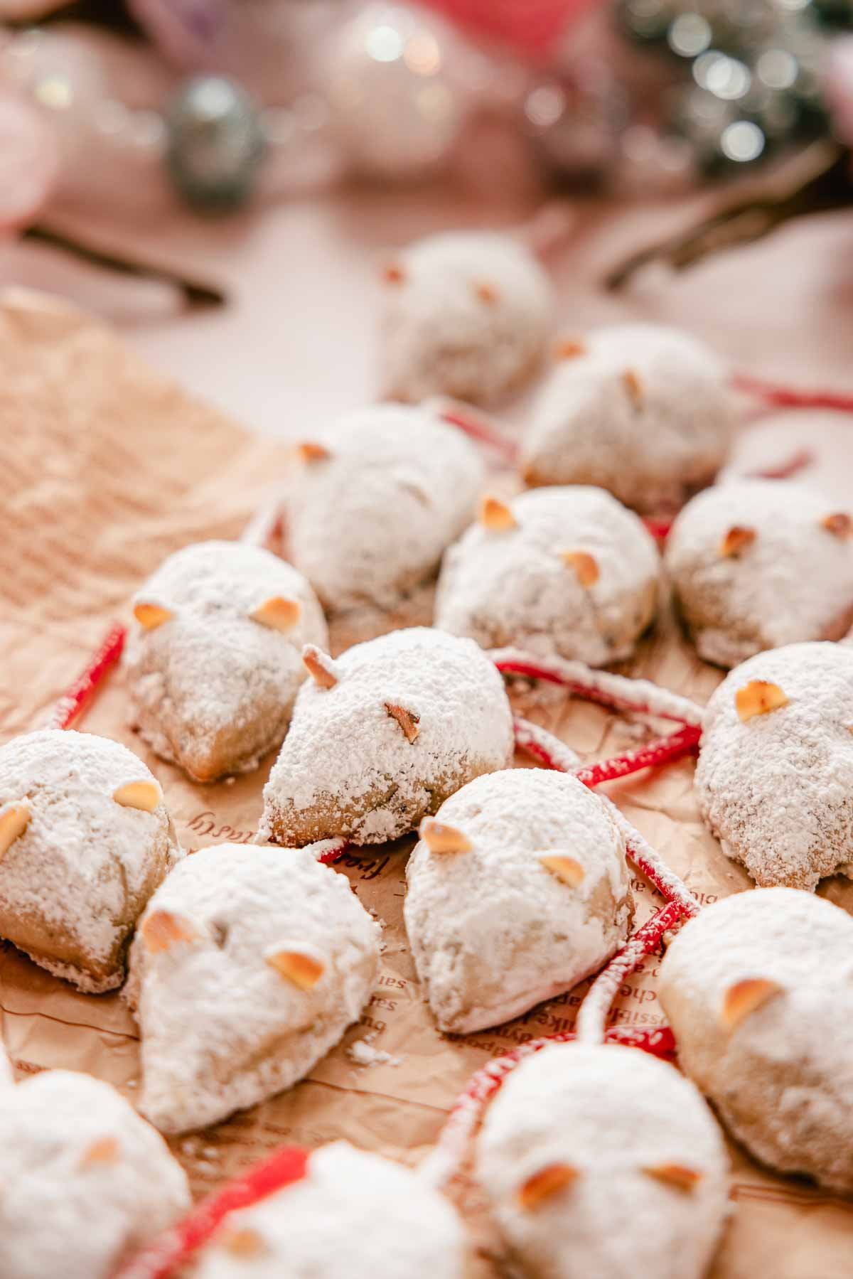 christmas mice cookies dusted with powdered sugar on parchment paper