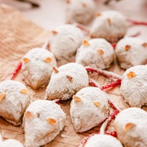 christmas mice cookies dusted with powdered sugar on parchment paper