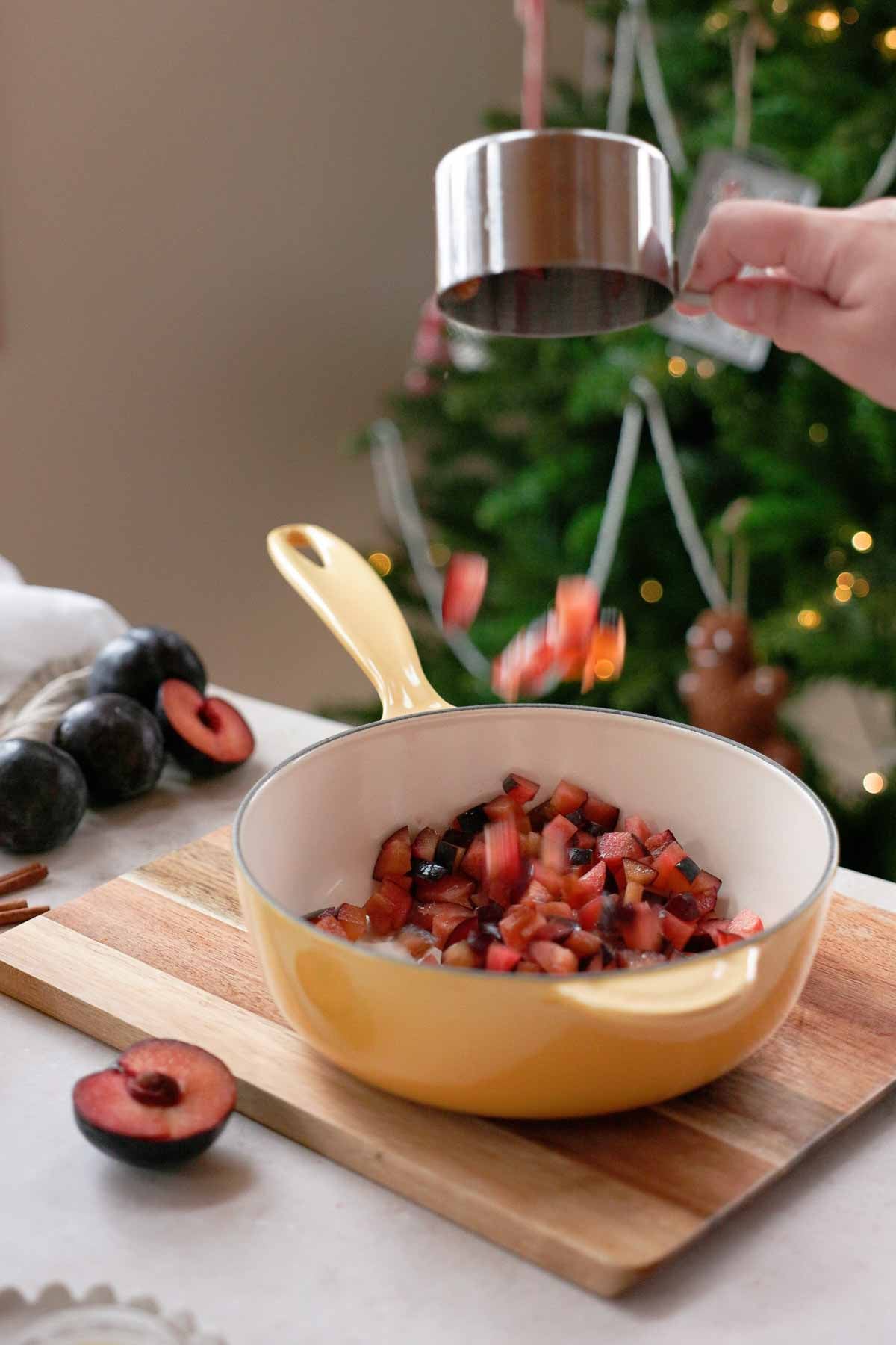 placing diced plums into saucepan
