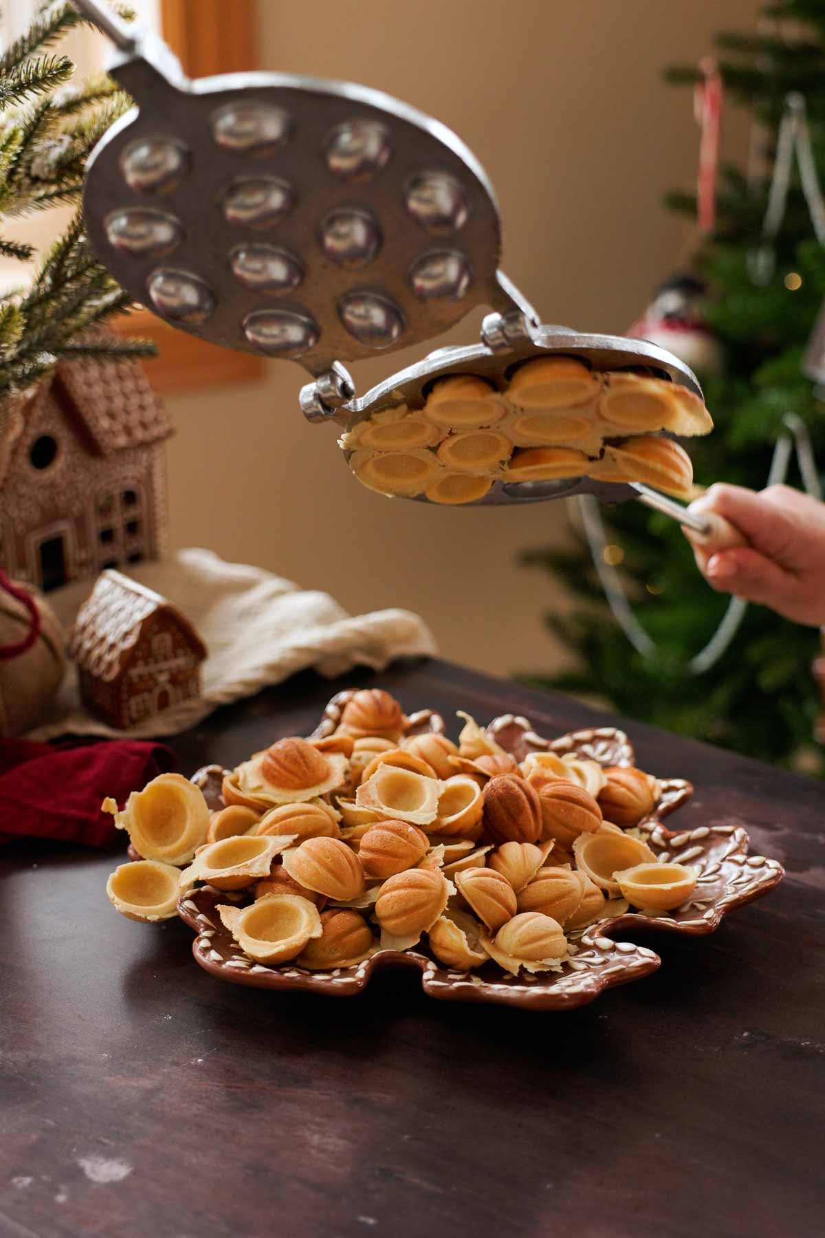 dumping freshly cooked walnut cookies out of the mold