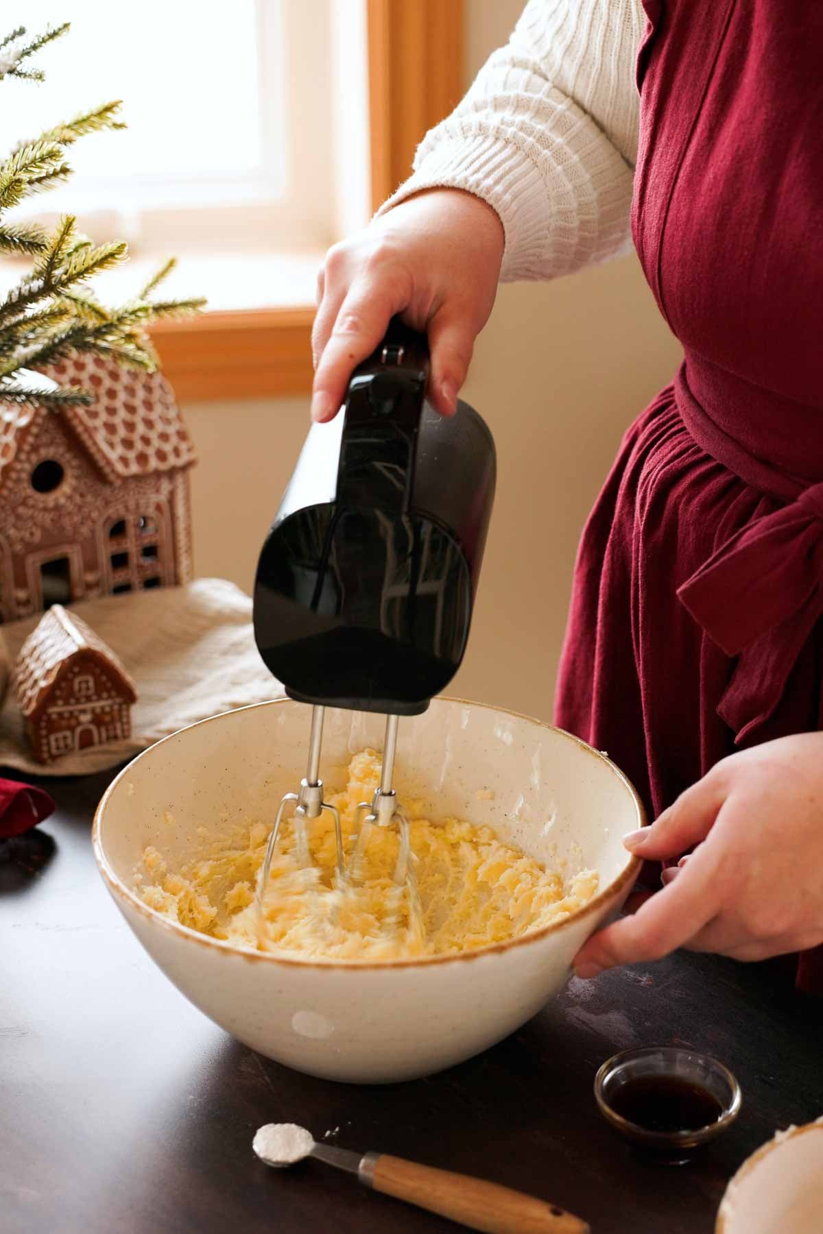 creaming butter and sugar in a large bowl with a handheld mixer
