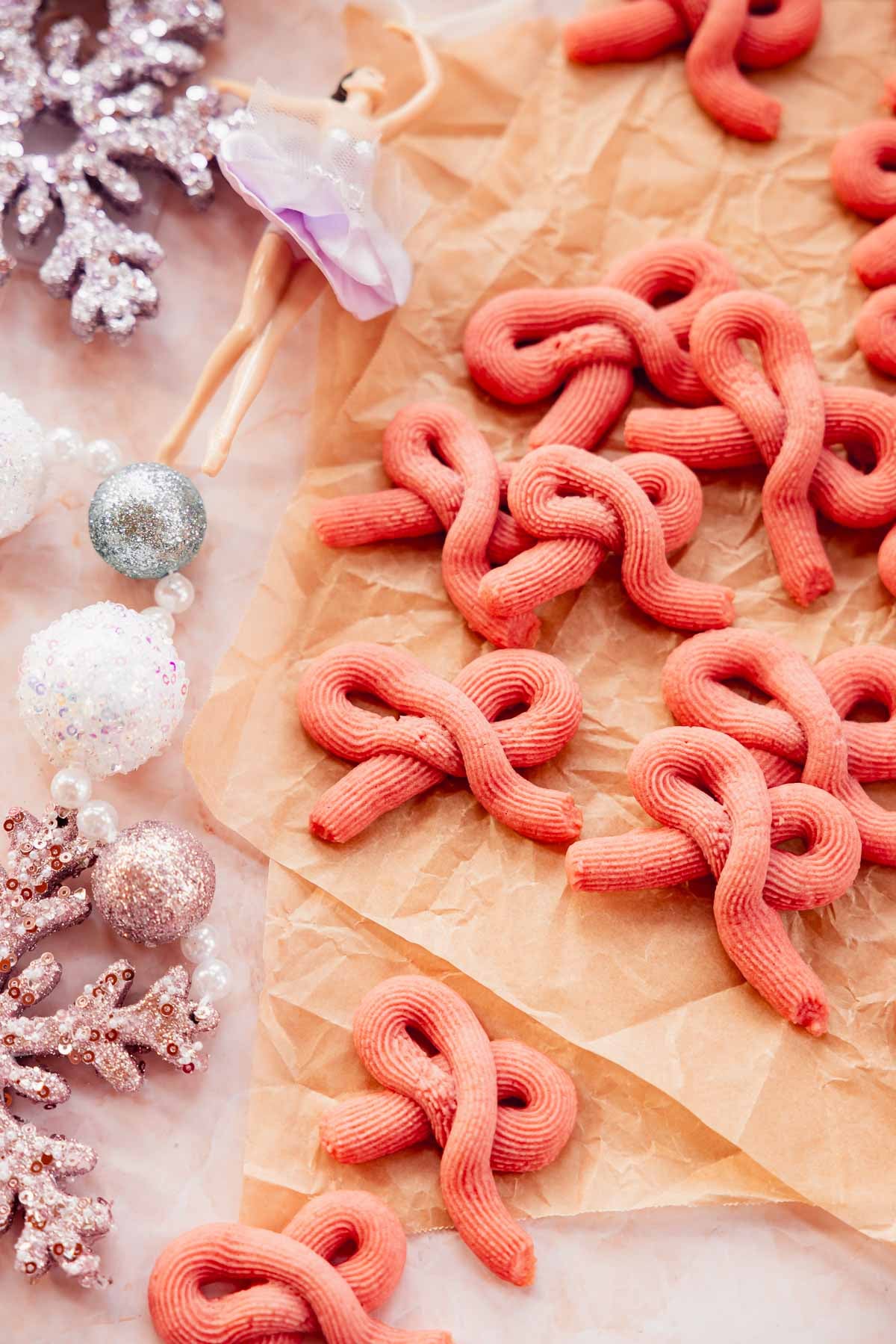 piped pink bow butter cookies on parchment paper