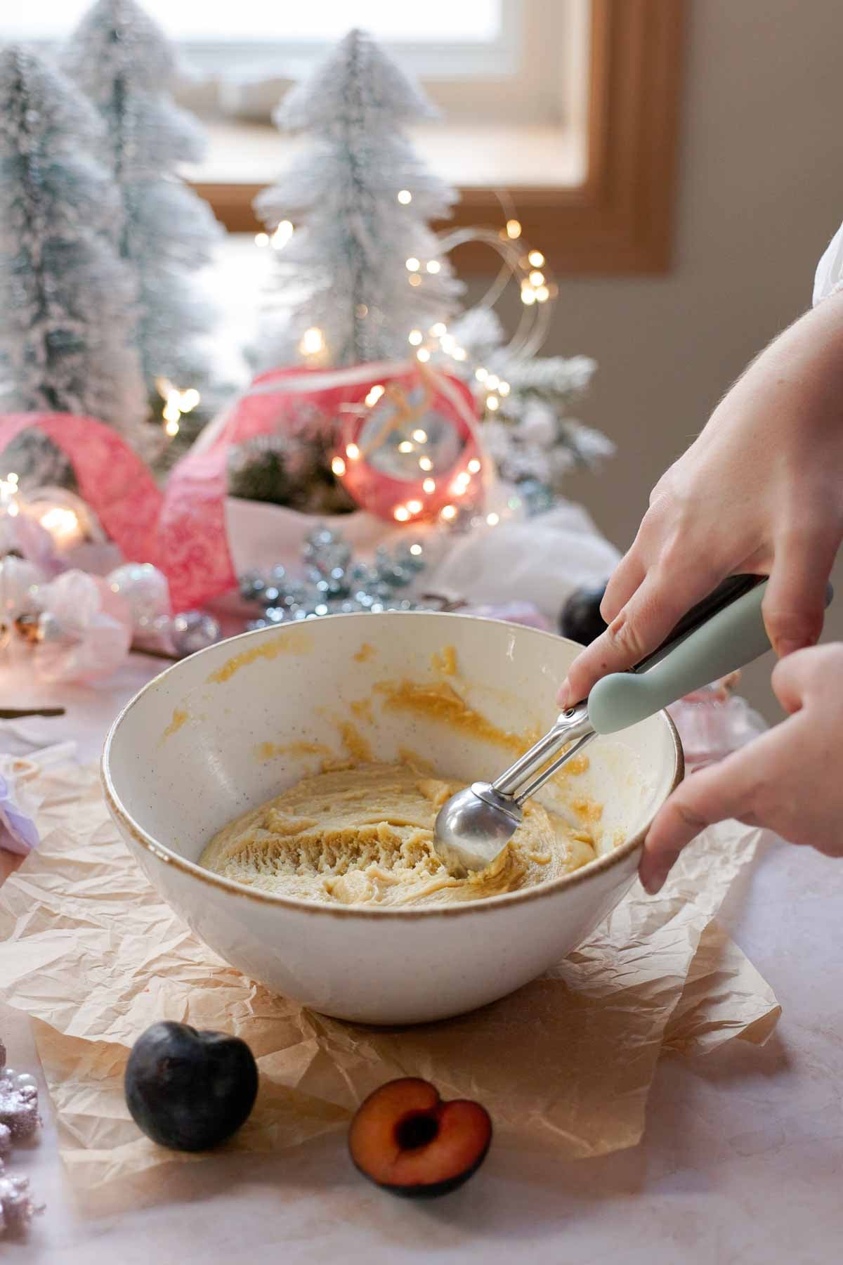 scooping sugar plum cookie dough into balls