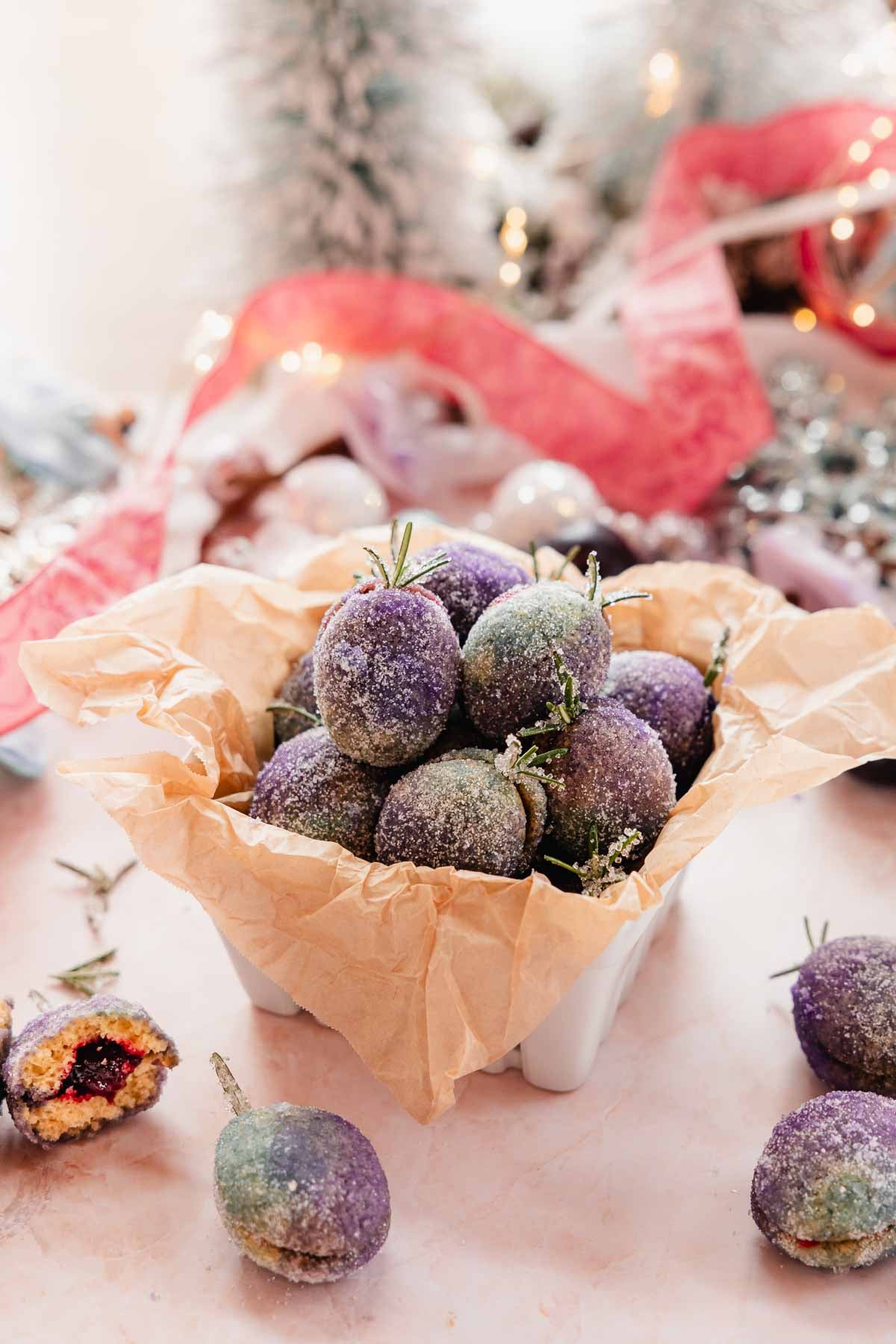 purple and blue sugar coated plum cookies in container