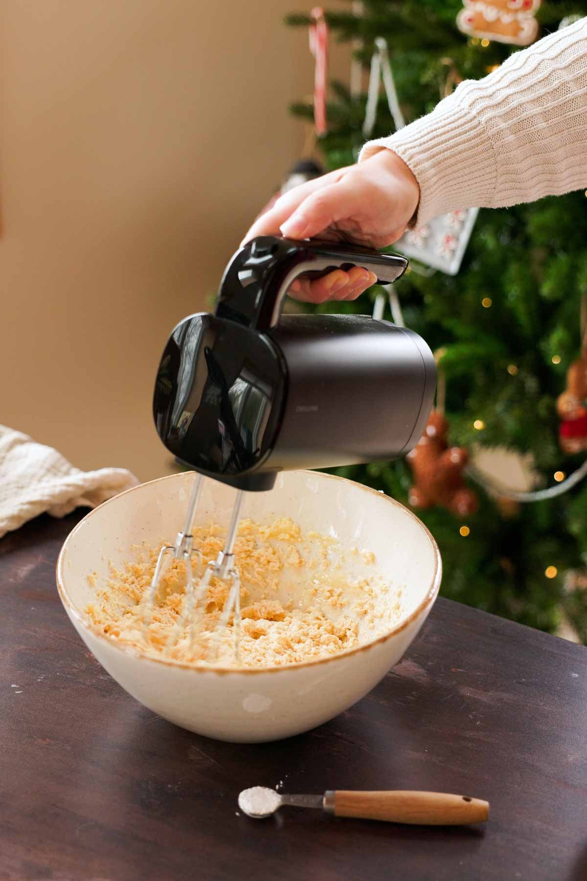 mixing together walnut cookie dough in large bowl