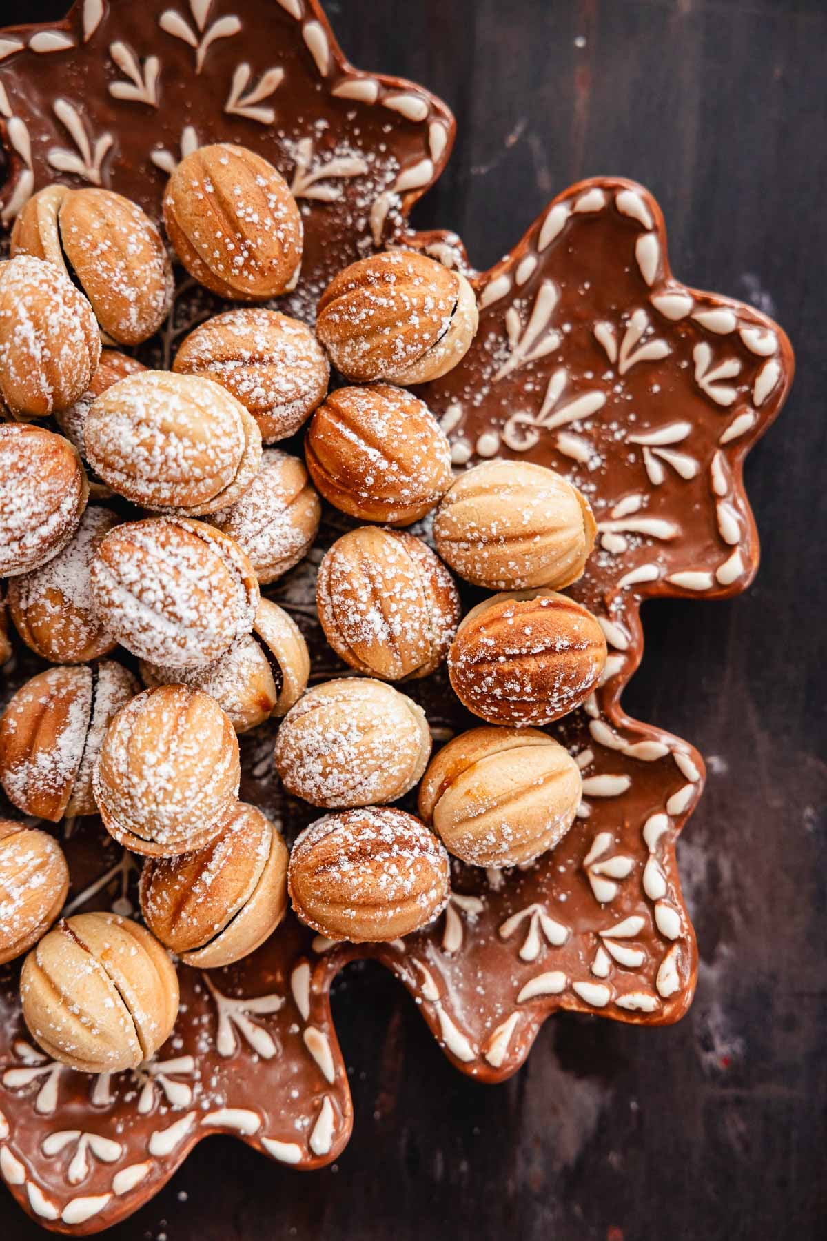 walnut shaped cookies aka oreshki on a snowflake plate