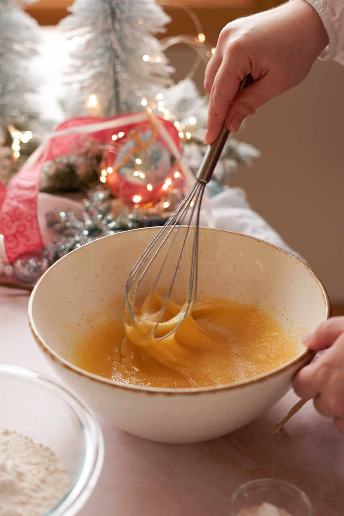 whisking eggs and sugar for sugar plum cookies