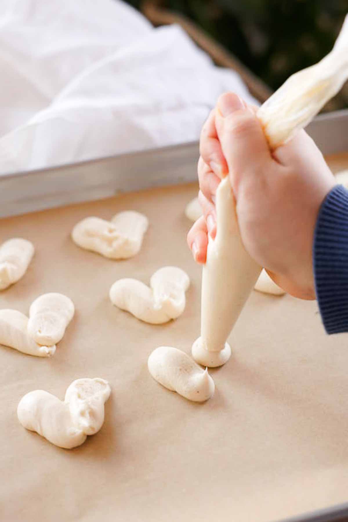 piping cream cheese filling into hearts using piping bag
