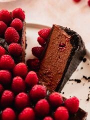 slice of chocolate raspberry no bake creamy cheesecake on cake plate